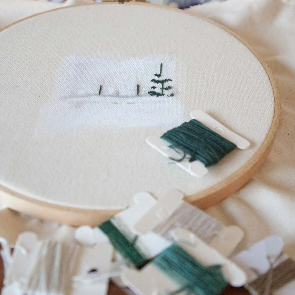 Mixed-media embroidery artwork featuring redwood trees created with paint and thread. This nature-inspired textile art combines hand embroidery and painted details to capture the texture, depth, and beauty of towering redwood forests.