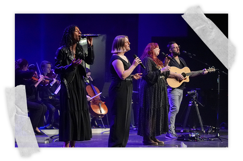 A diverse worship team leads music onstage at a past Good Friday service at Spanish River Church