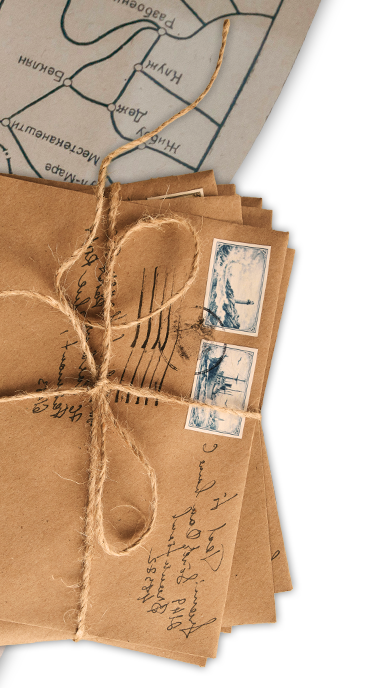 Decorative elements: a stack of old letters wrapped in twine, and and a road map