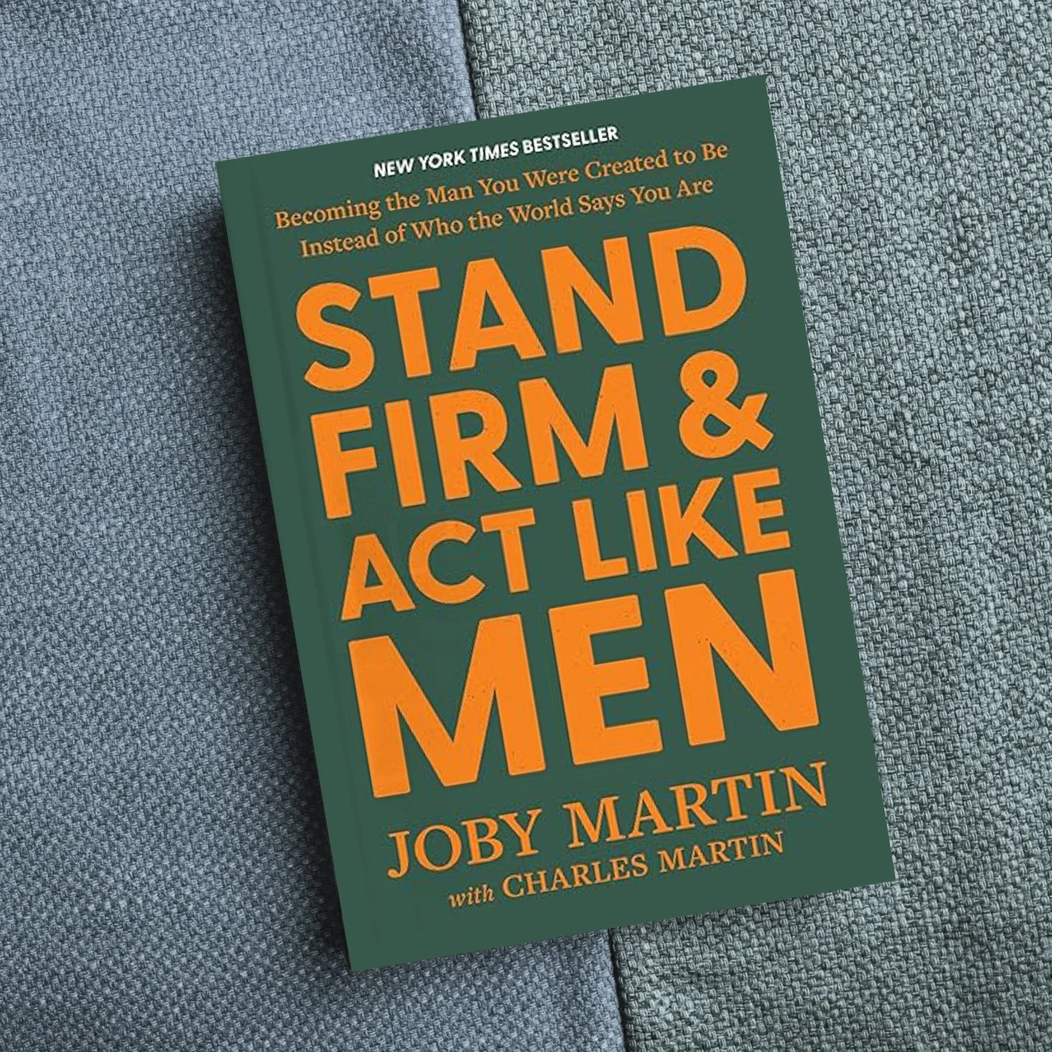 Book titled "Stand Firm & Act Like Men" by Joby Martin with Charles Martin, resting on a gray fabric surface.