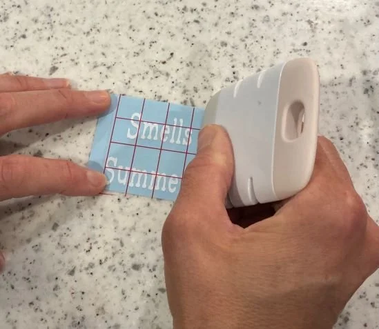 Smooth the tape over the words.