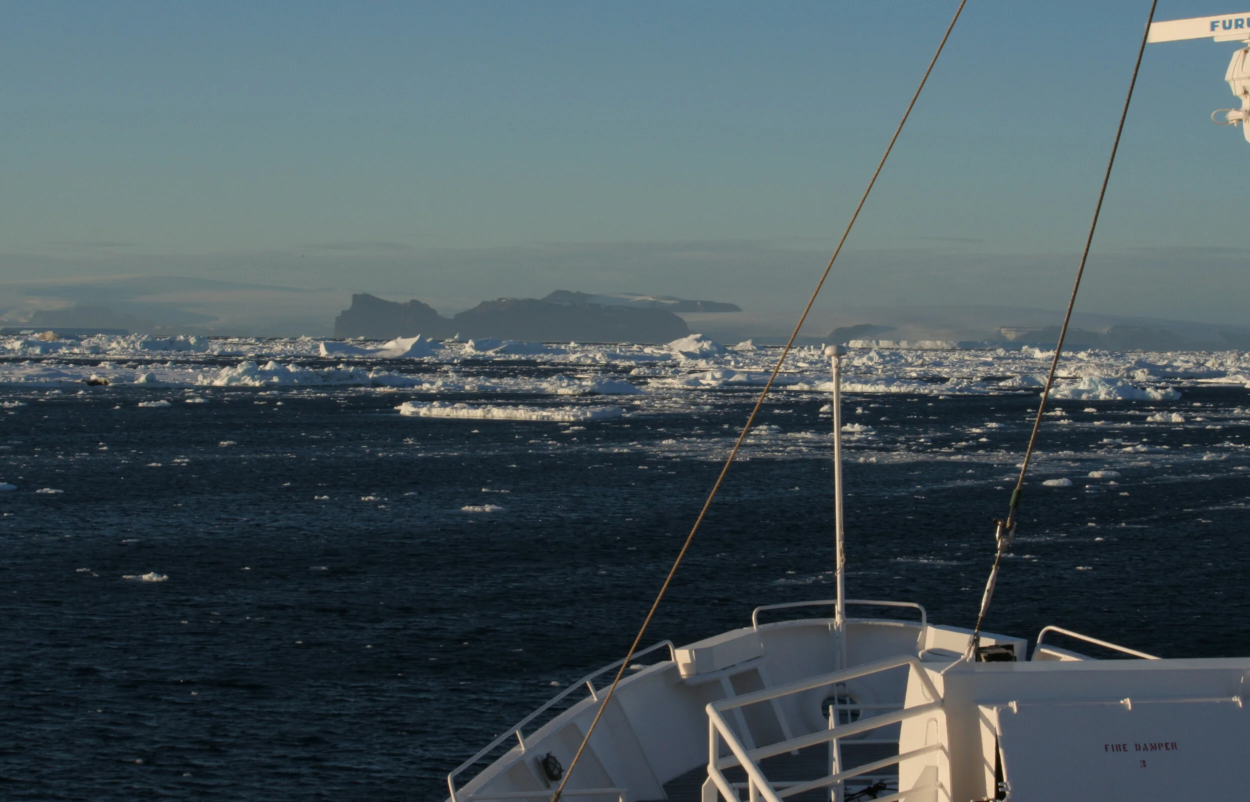 bow of research vessel on sea of floating ice