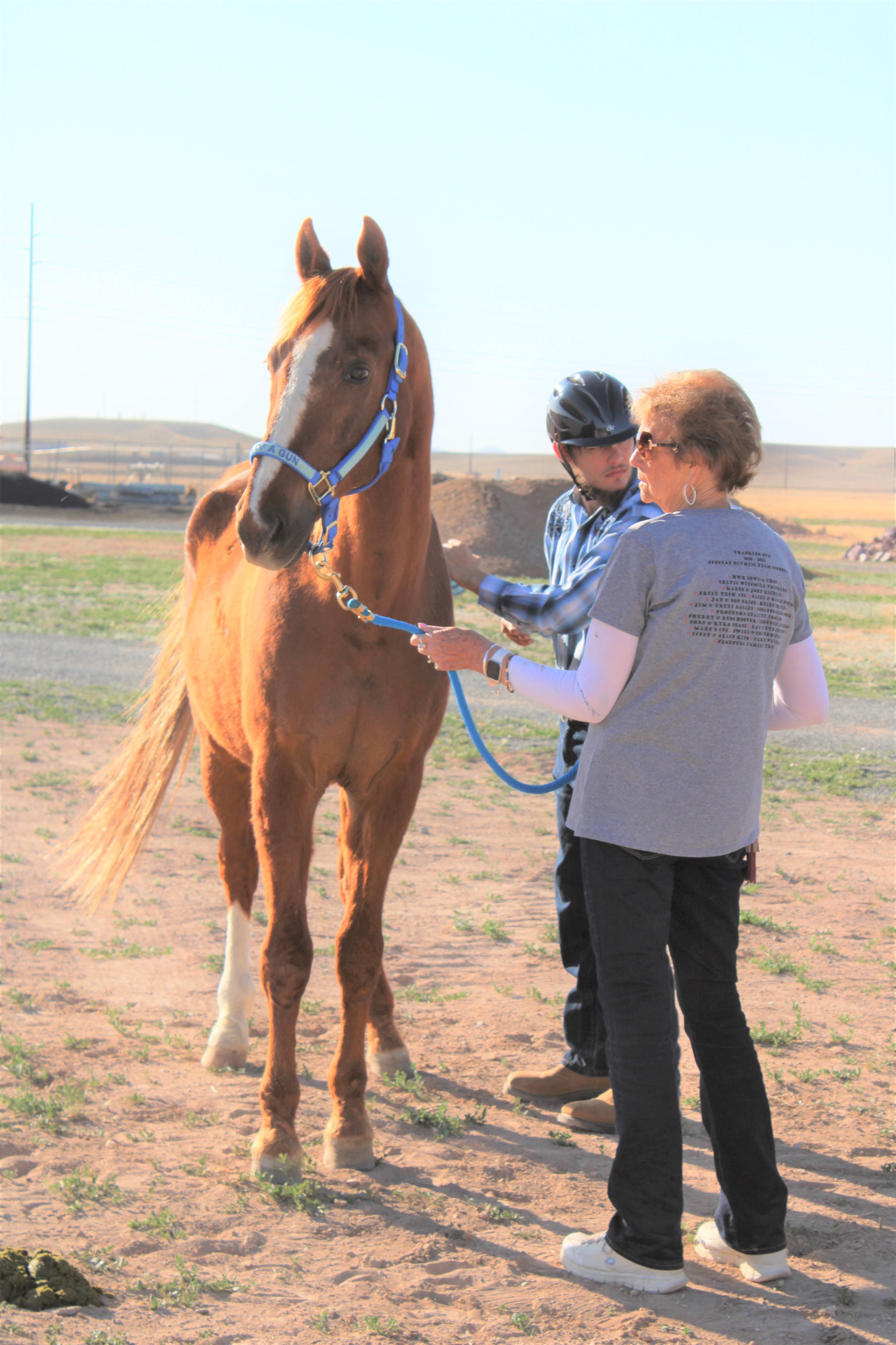 Helen holding Son while Sean grooms.JPG