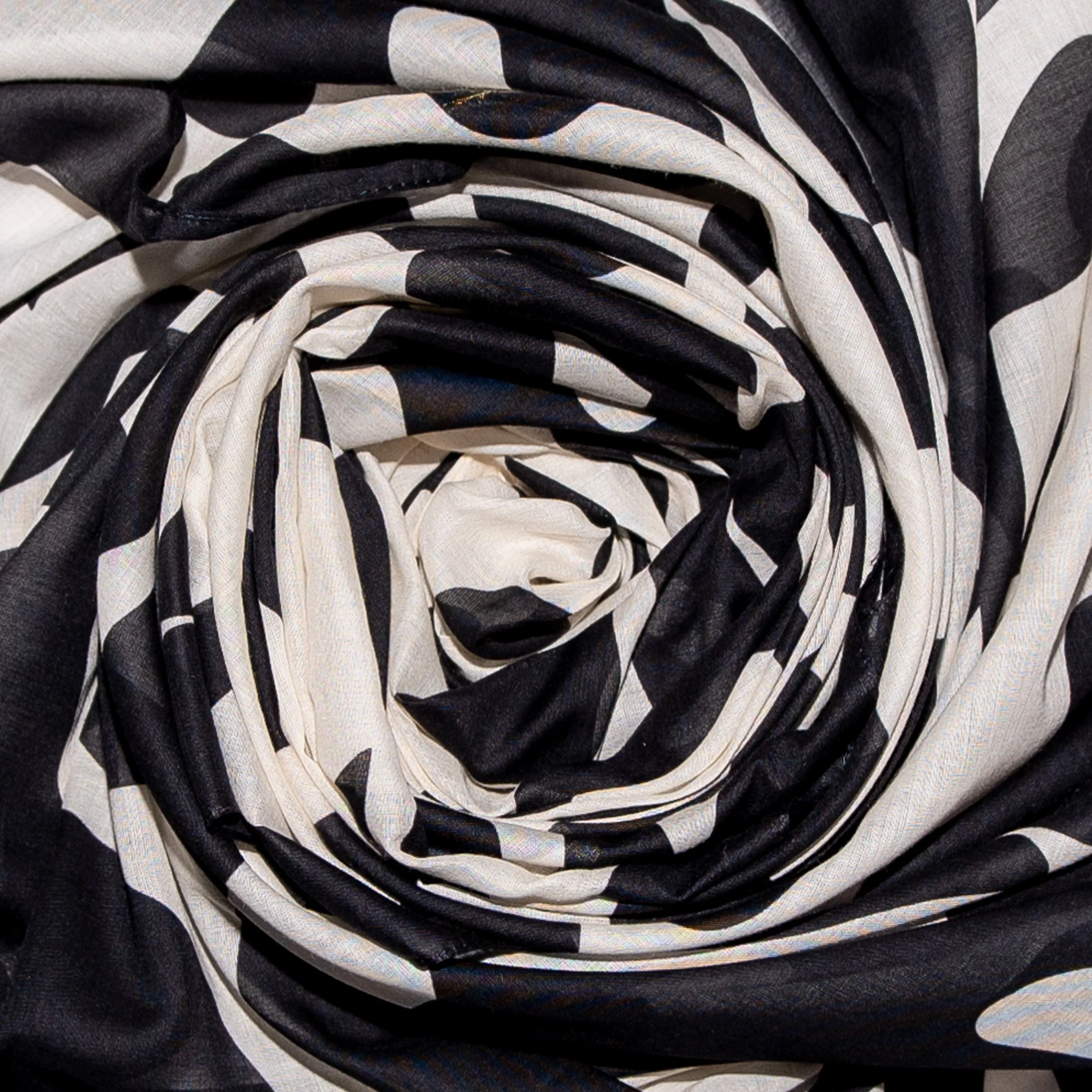 Black and white bird and palm leaf rectangular scarf swirled closeup of fabric