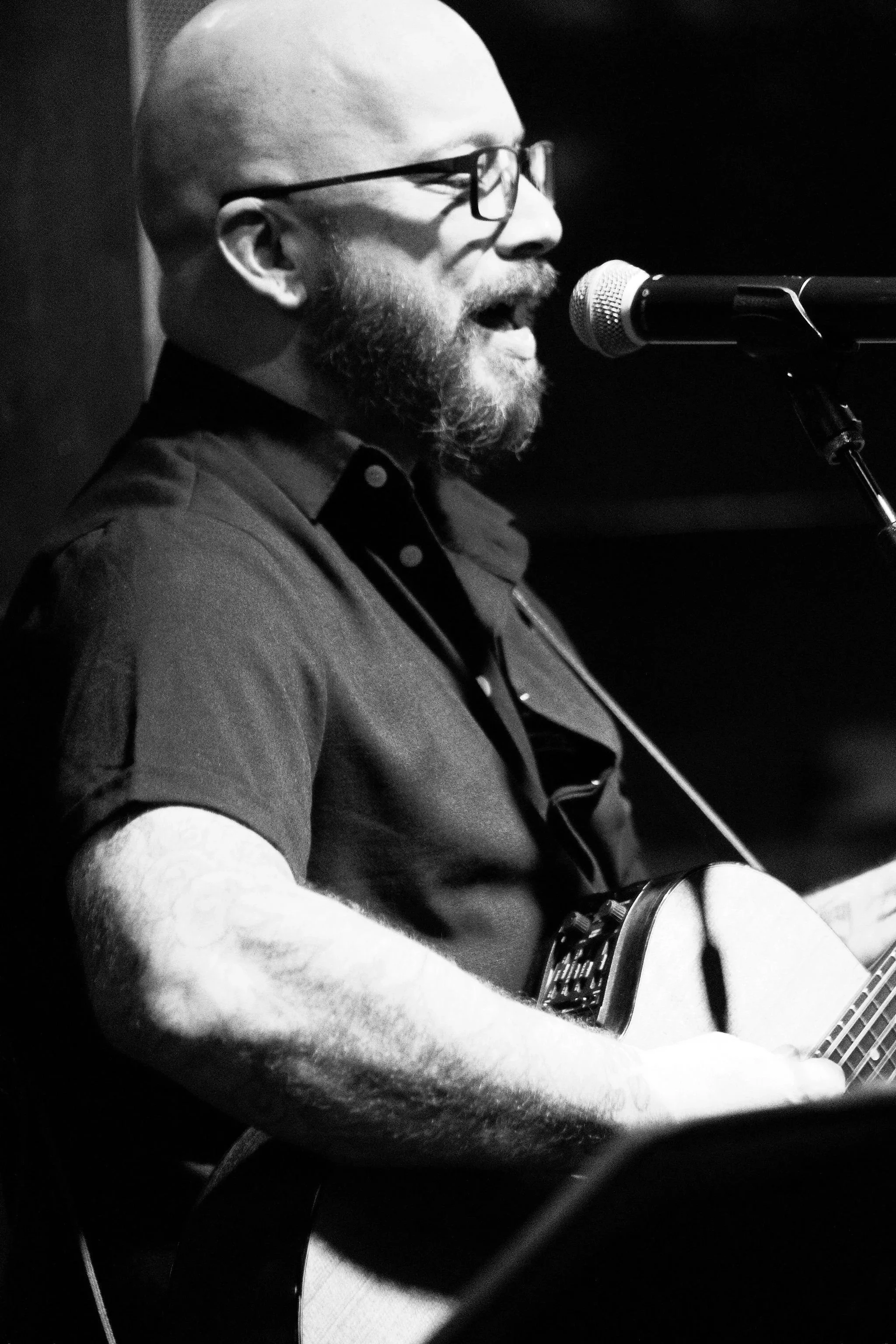 Ted singing and playing guitar at a live show