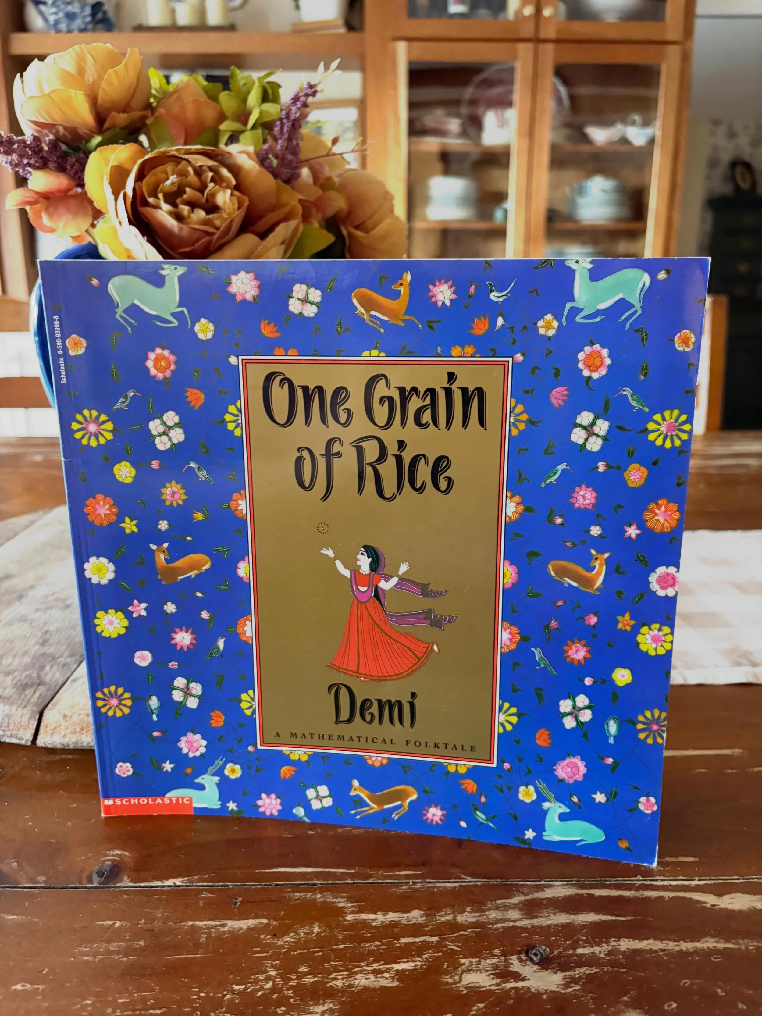&ldquo;One Grain of Rice: A Mathematical Folk Tale&rdquo; by Demi, 1997

&ldquo;A reward of one grain of rice doubles day by day into millions of grains of rice when a selfish raja is outwitted by a clever village girl.&rdquo;

Paperback, brand new! 
