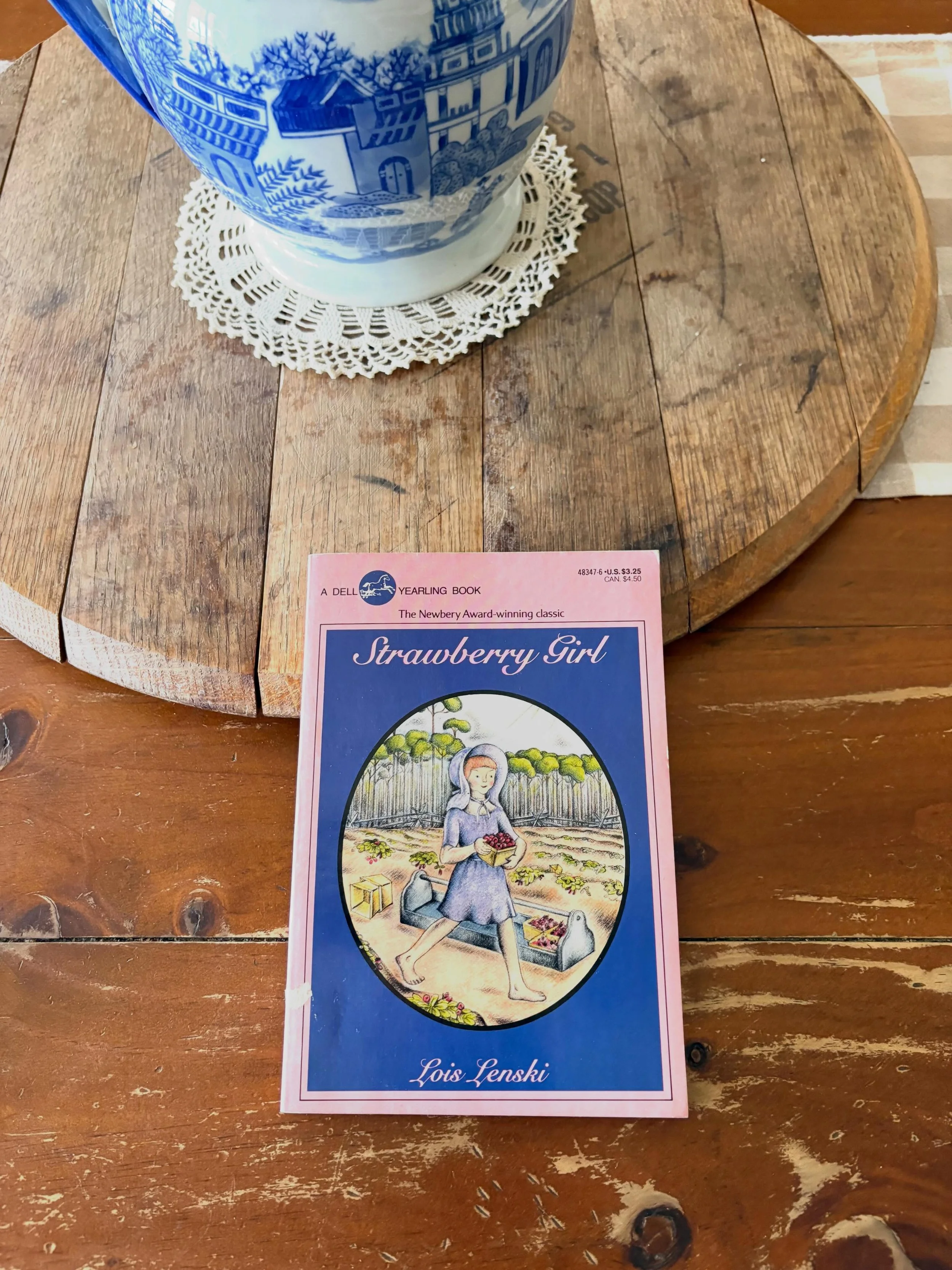 &ldquo;Strawberry Girl&rdquo; by Lois Lenski, 1987

&ldquo;The land was theirs, but so were its hardships

Strawberries &mdash; big, ripe, and juicy. Ten-year-old Birdie Boyer can hardly wait to start picking them. But her family has just moved to th