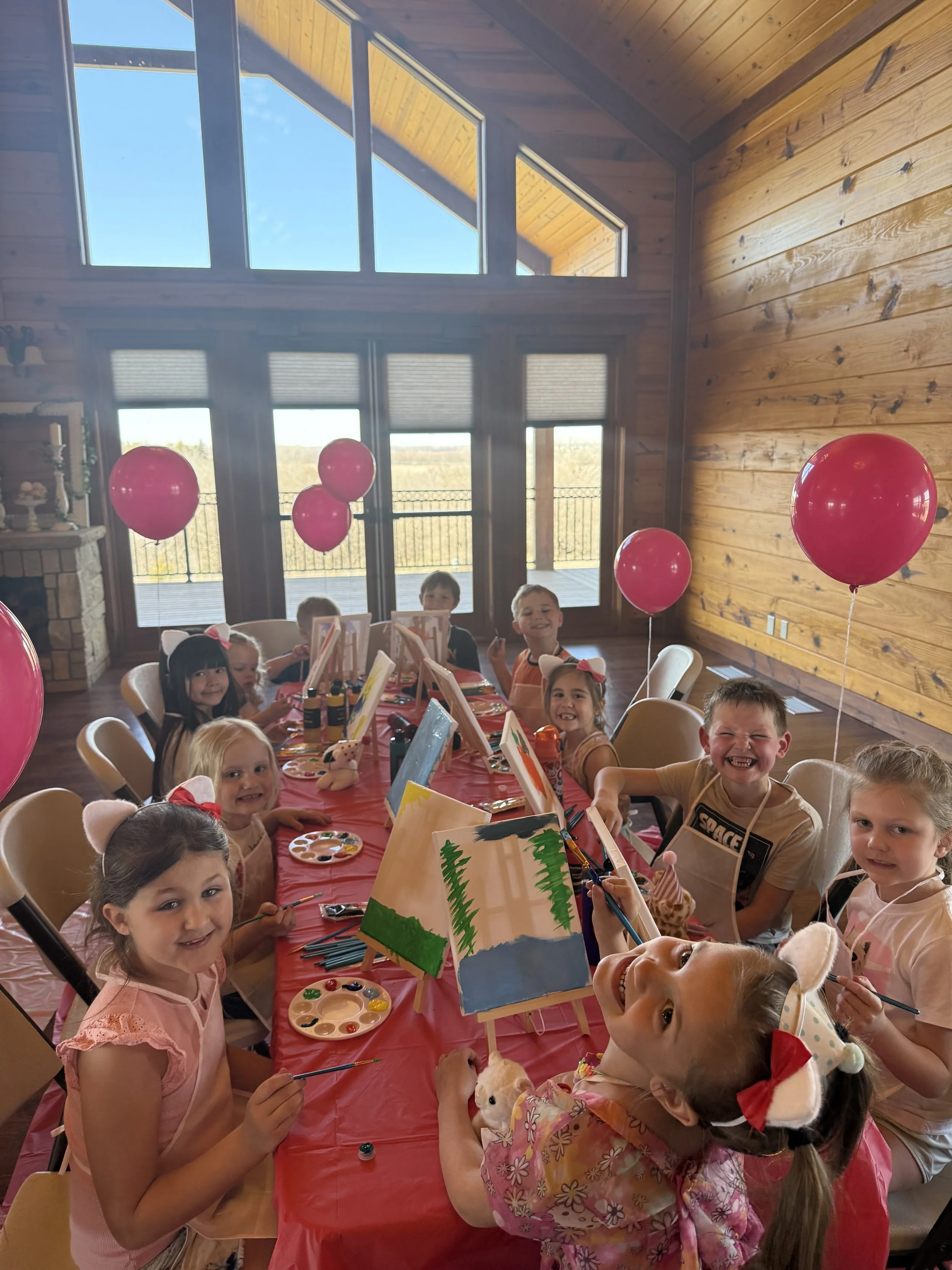 Kids at birthday party gathered around table at Clay Center, KS venue.