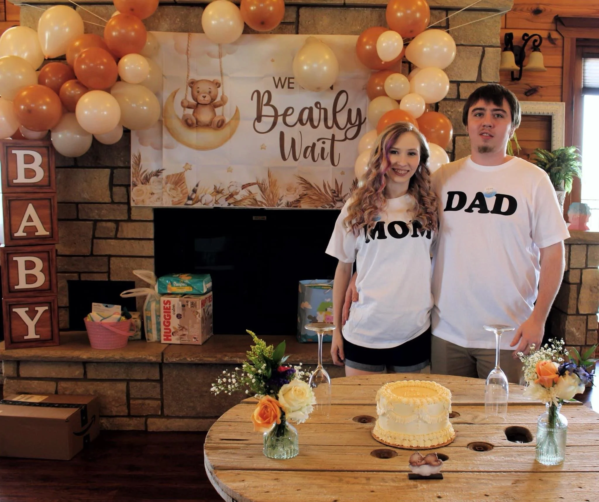 Baby reveal for a Mom and Dad with balloons and cake