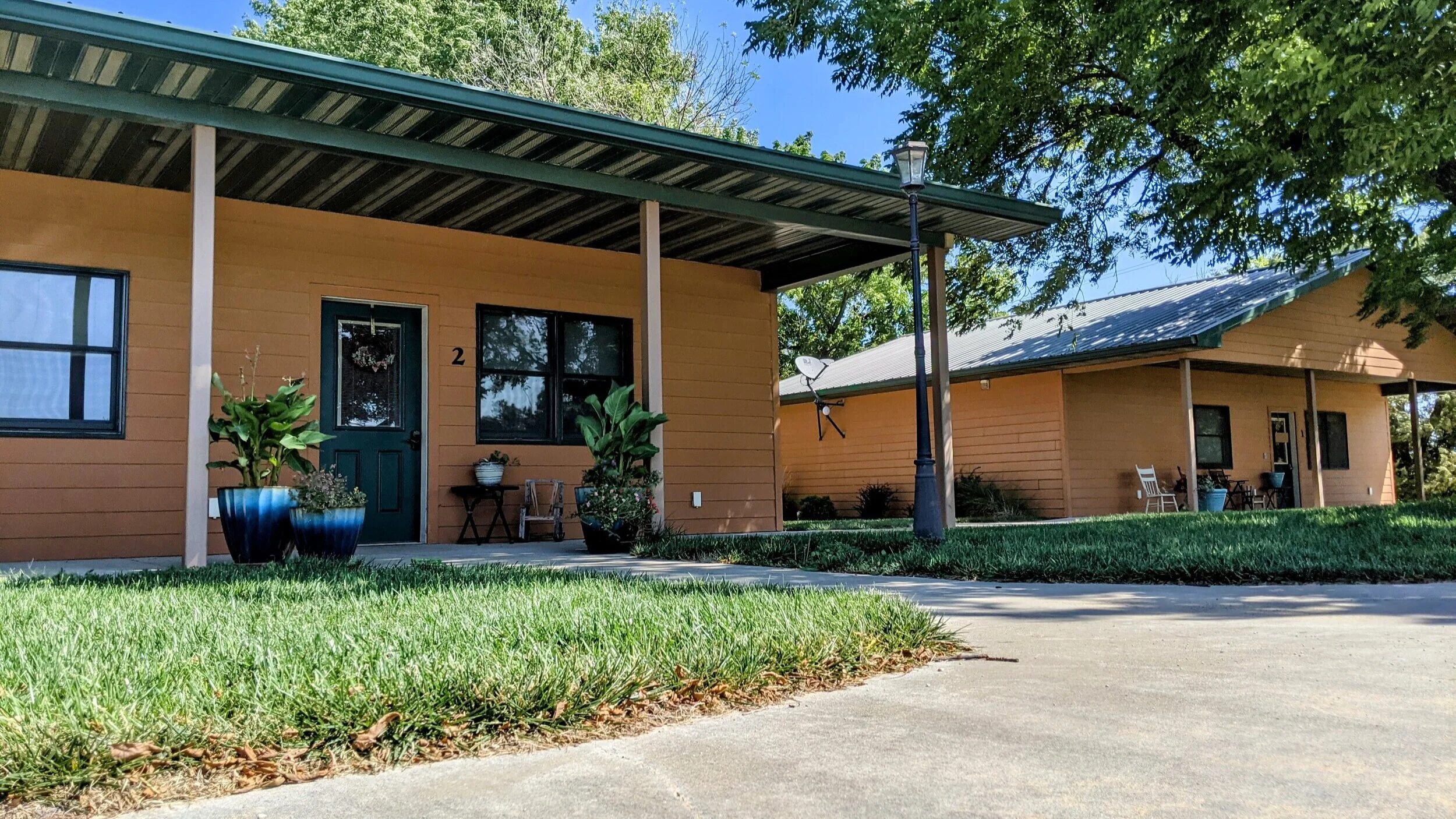 Outside fronts of 2 tan cabins in Spring in Clay Center, KS