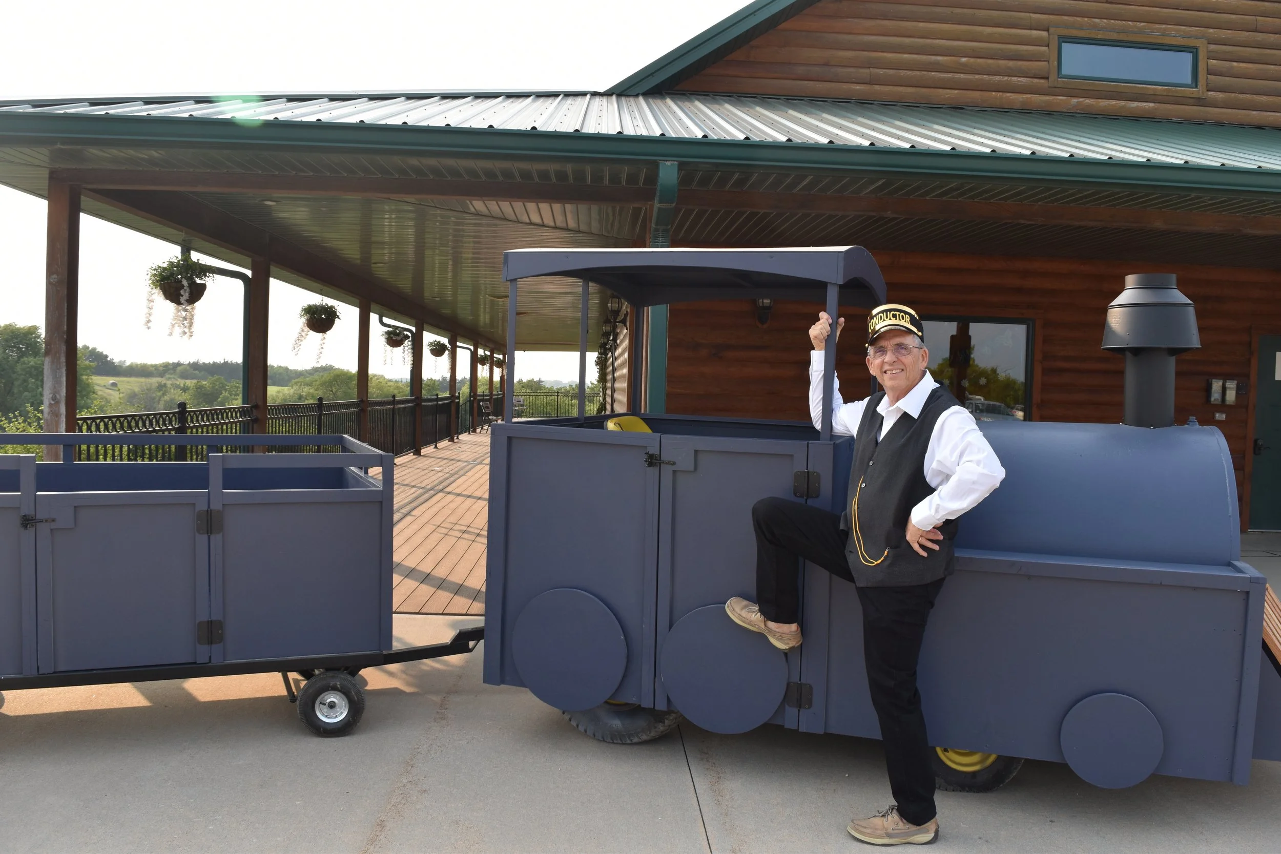 Conductor showing motored train ride for kids at event venue in Clay Center, KS