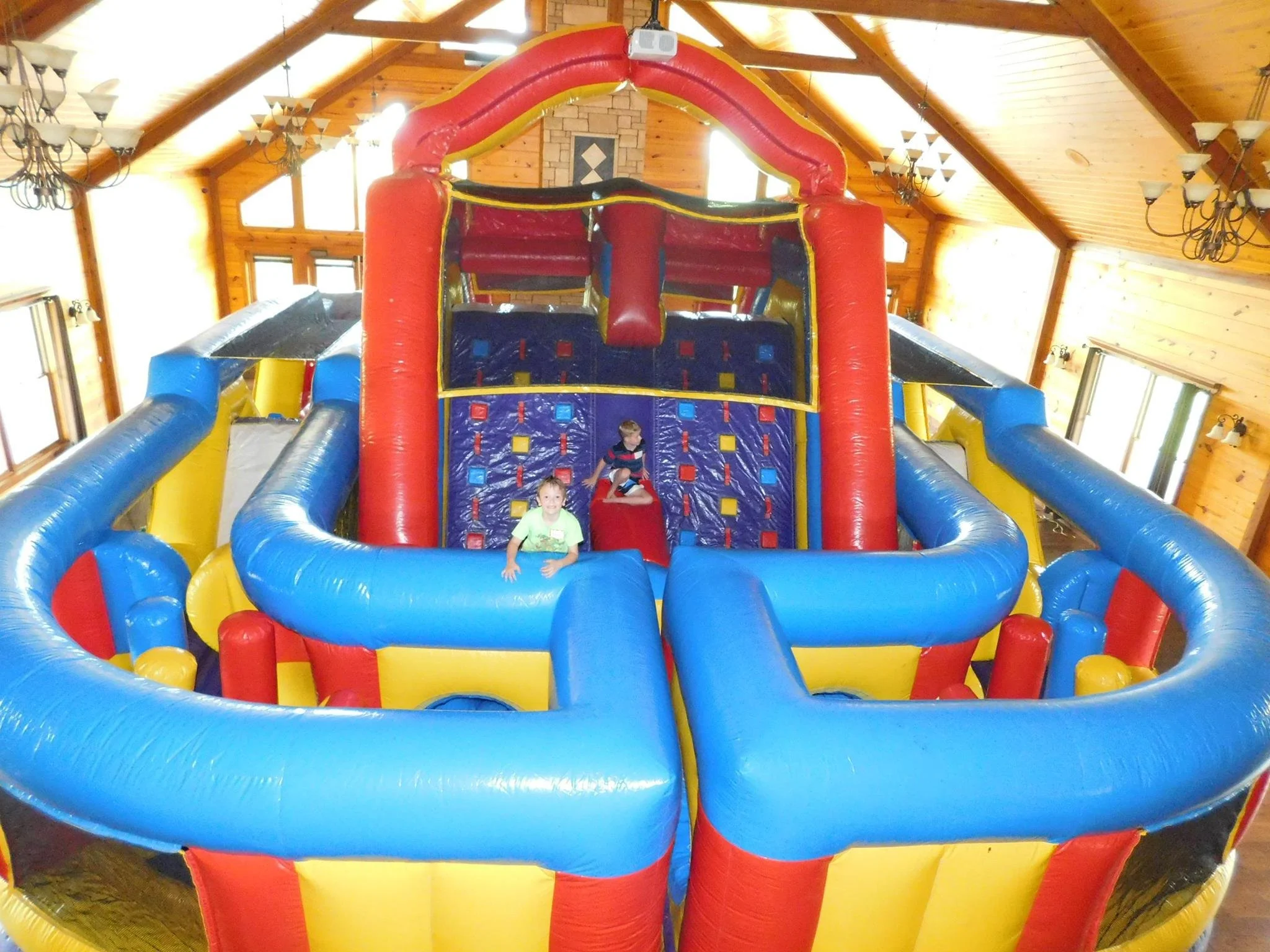 Giant sized bounce house in tall great room of Clay Center venue.