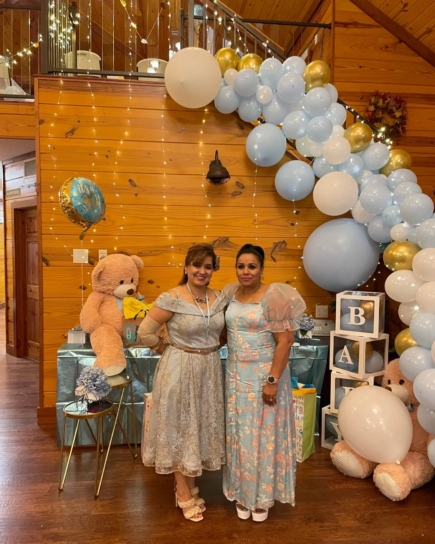 Grandmothers in front of giant bears and balloon display at baby shower