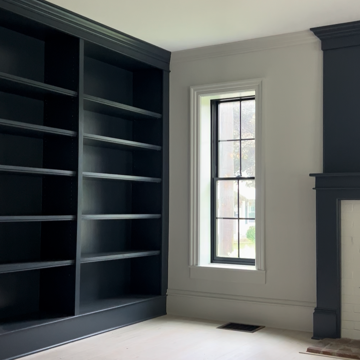 Window replacements and a custom built-in bookshelf and fireplace mantel installed during a home renovation in Hamilton, NY
