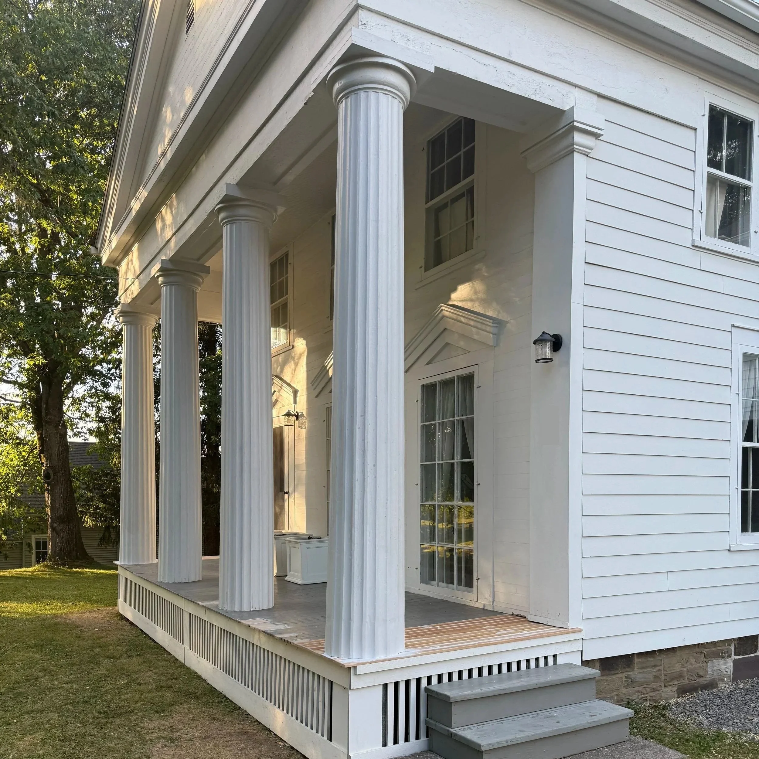 Doric columns on a Greek Revival home in Hamilton, NY restored by carpenters and a general contractor. 