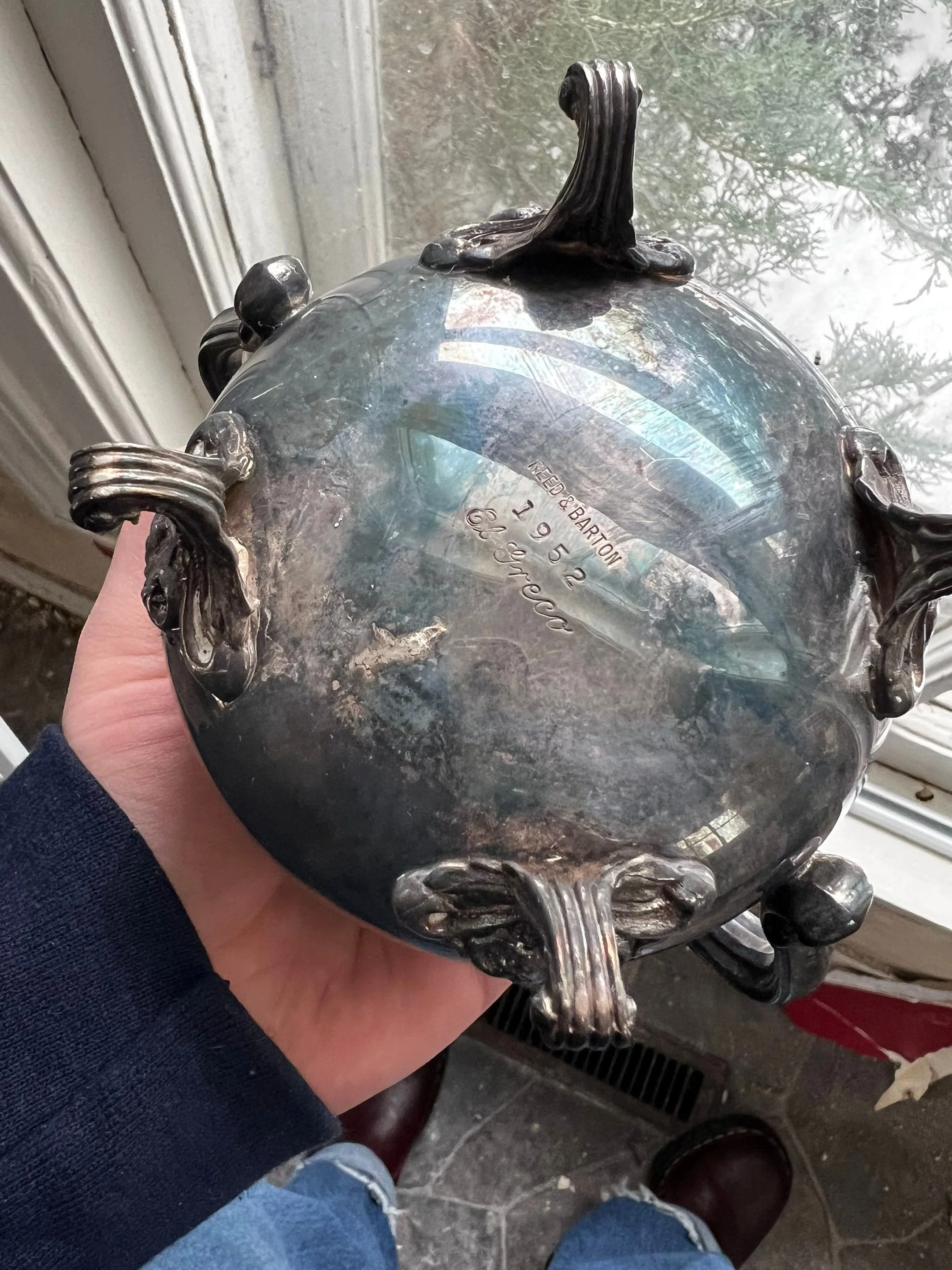 The bottom of an old silver pot from 1952 found in the walls of an old home
