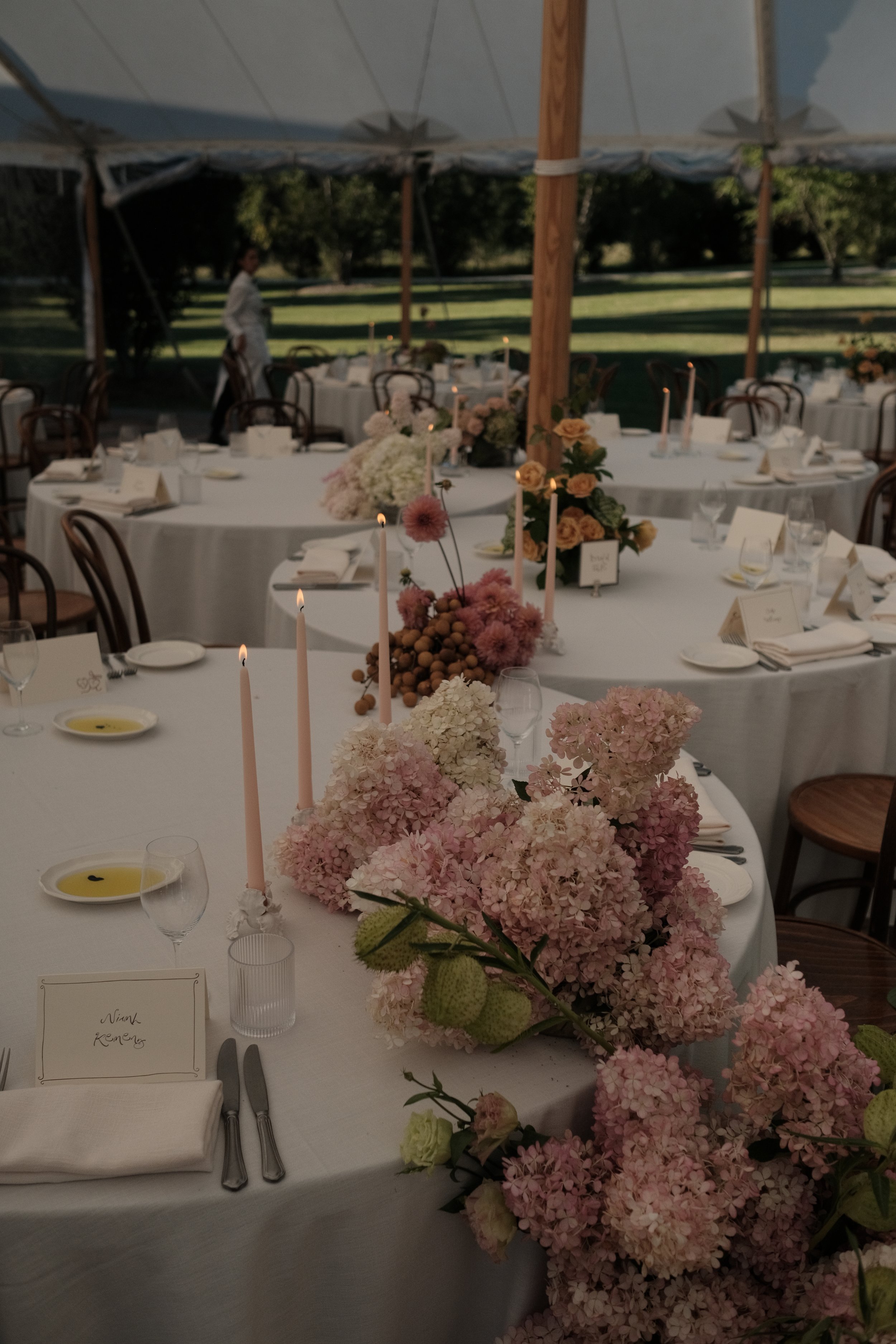 Wedding reception tablescape at Redleaf Wollombi, round tables with floral centrepieces, hydrangeas and candles by The Naked Florist