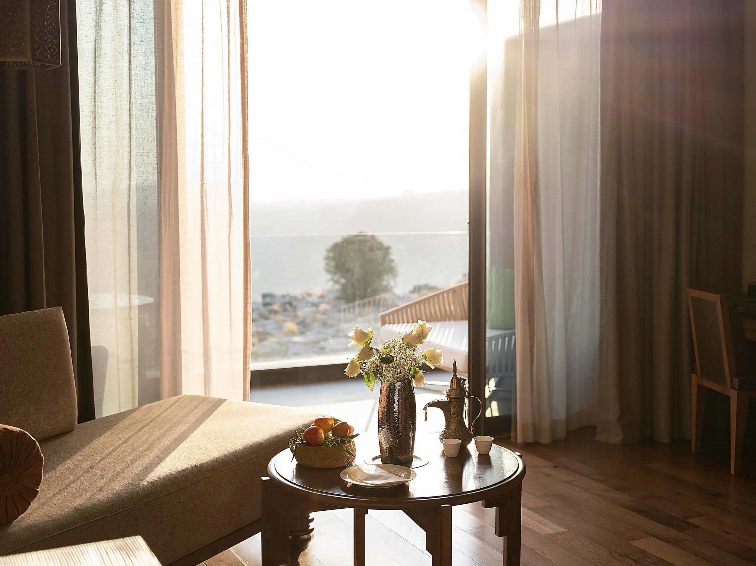 Anantara Al Jabal Akhdar - Deluxe room with cliff view sun beaming inside during sunset