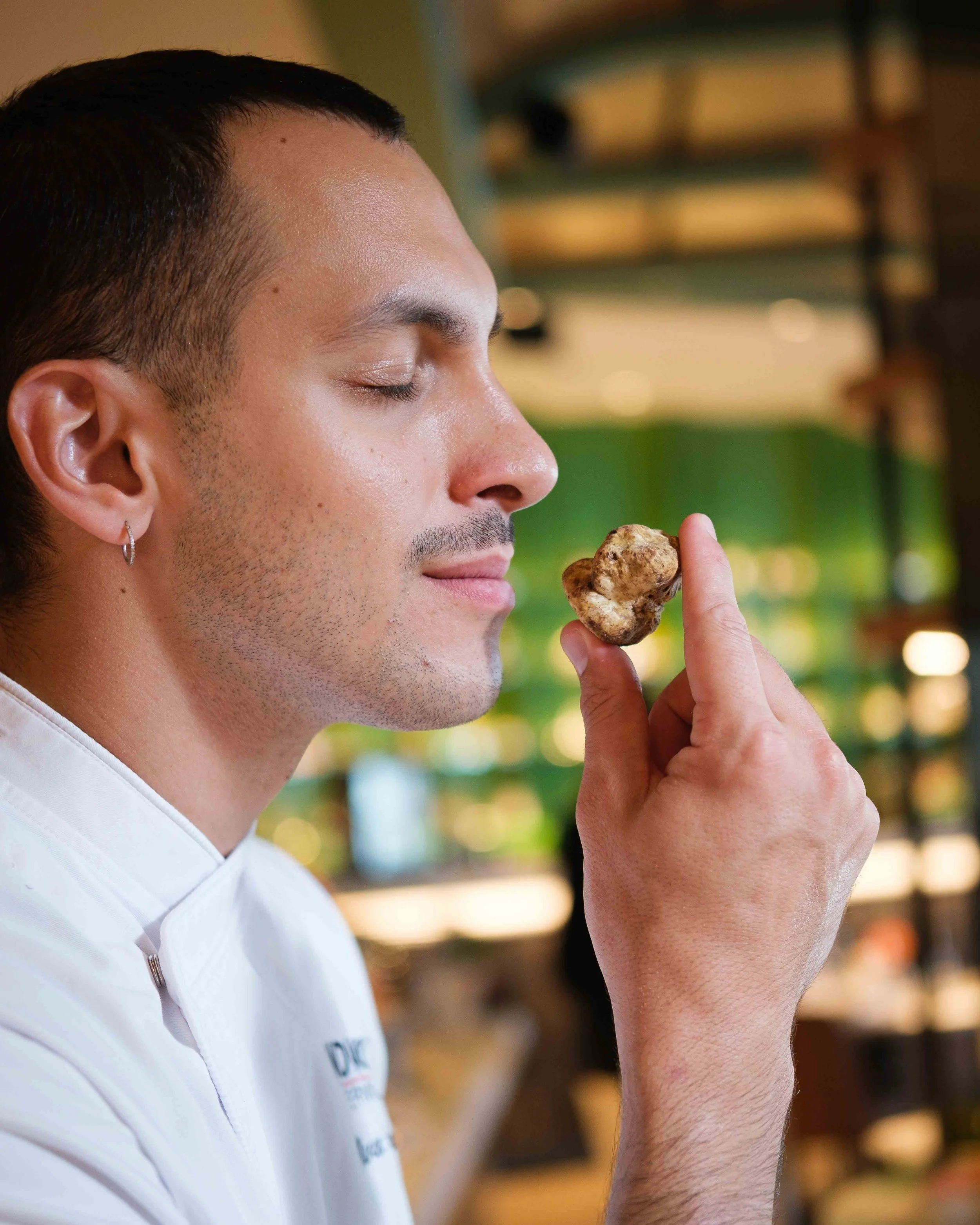 Young chef sniffing truffle