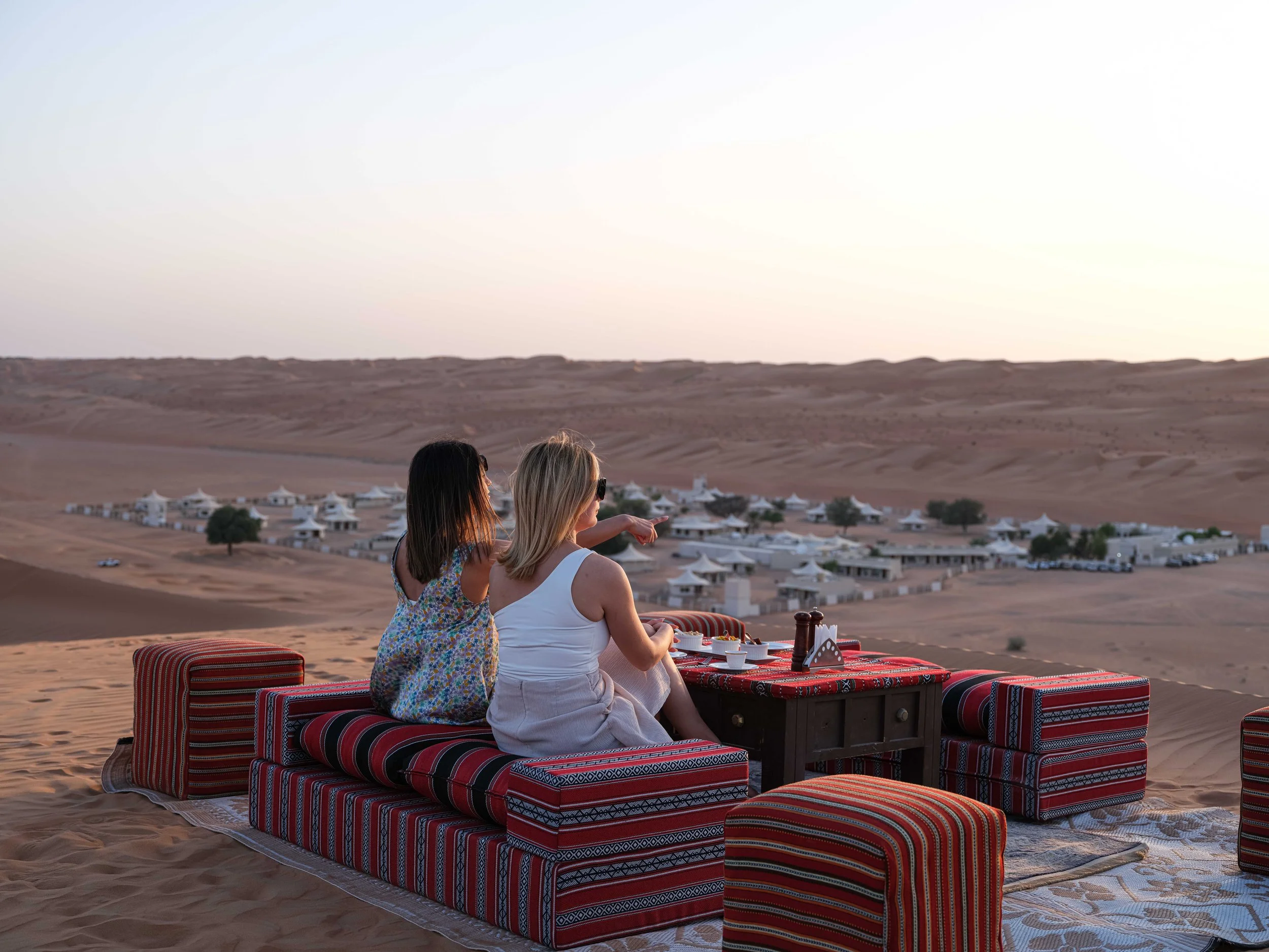 ladies watching sunset in desert camp