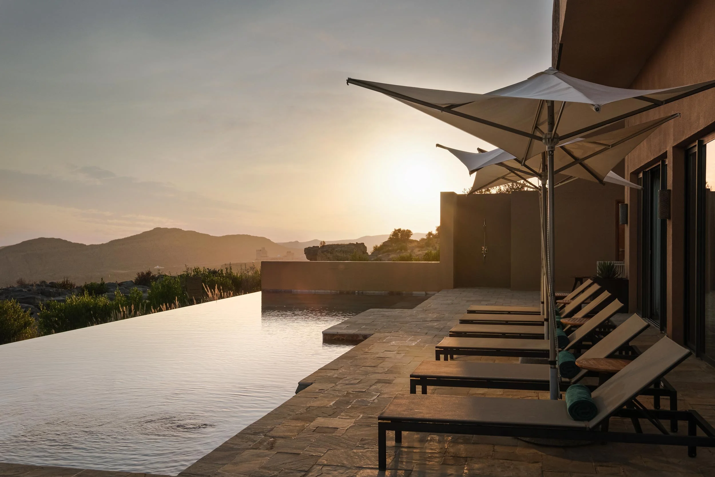 Anantara Al Jabal Akhdar - Royal Suite pool during sunset with mountain and cliff view in background