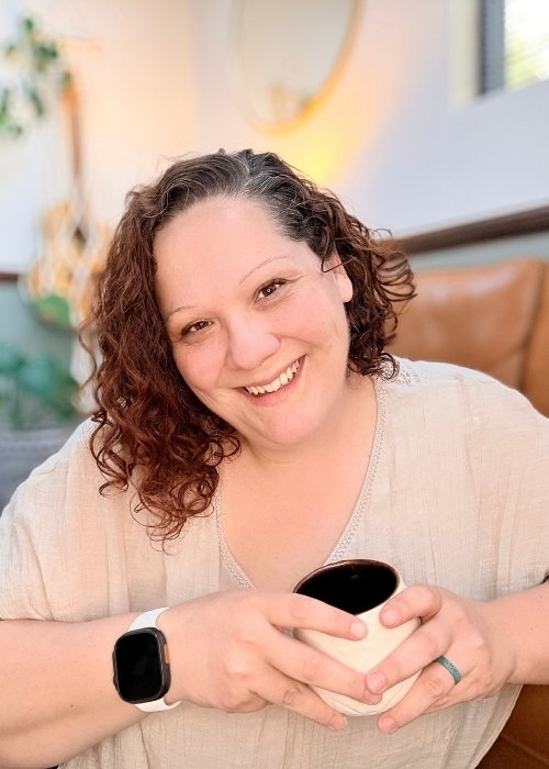 Kandace Ledergerber, laughing with a cup of coffee