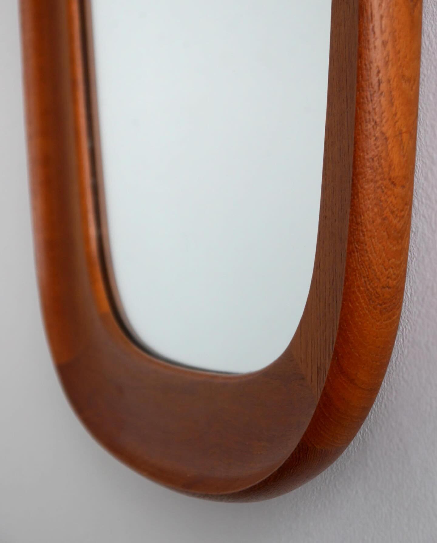 Mid-century Danish teak mirror, circa 1960s. Beautifully curved profile, in excellent condition.