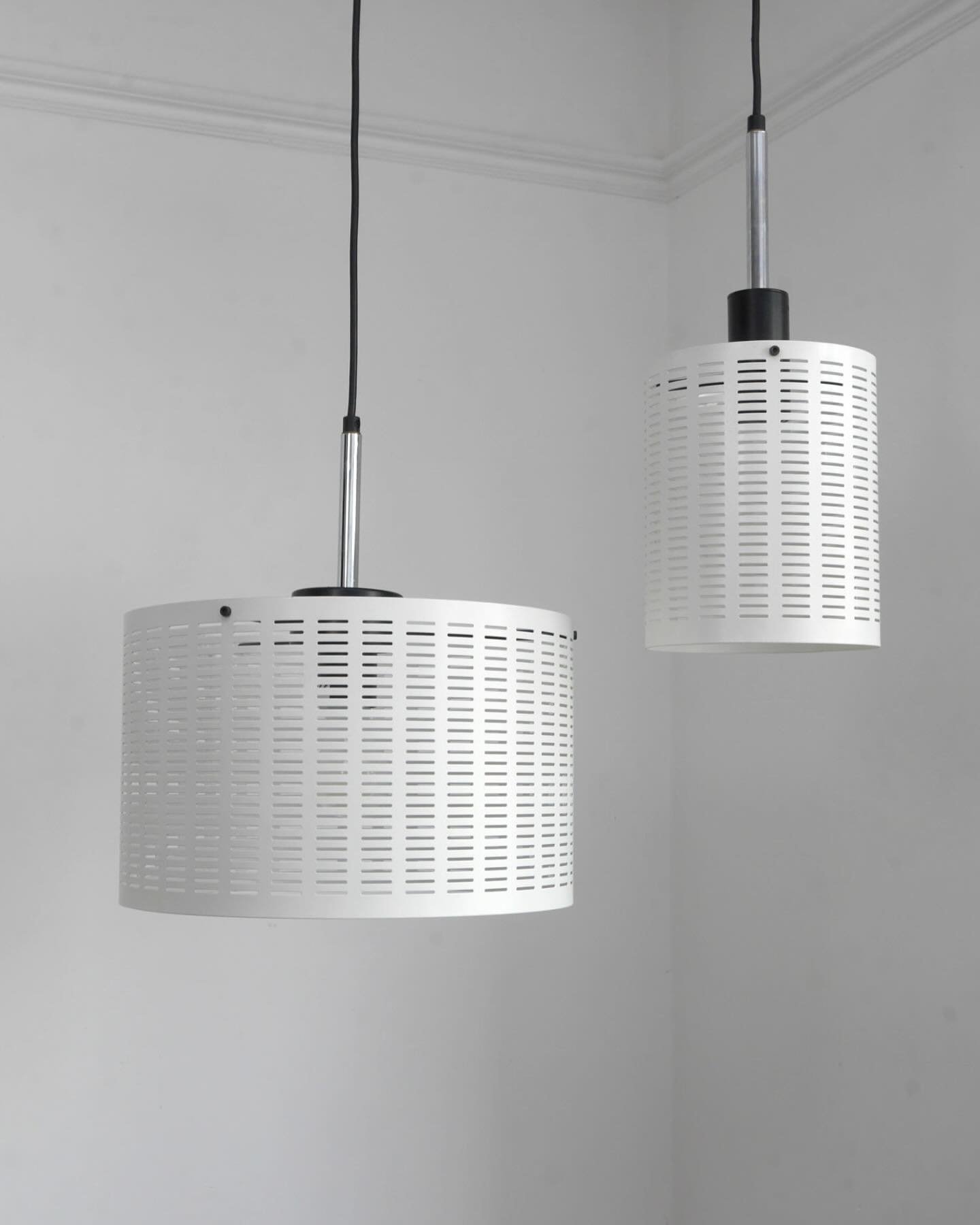 Apollo pendant lights designed in 1998 by Robert Welch and made by Chad Lighting, Birmingham, UK. No longer in production, these are new old stock.

Perforated white enamelled steel shade with black and stainless steel fittings.

&pound;195 for the l