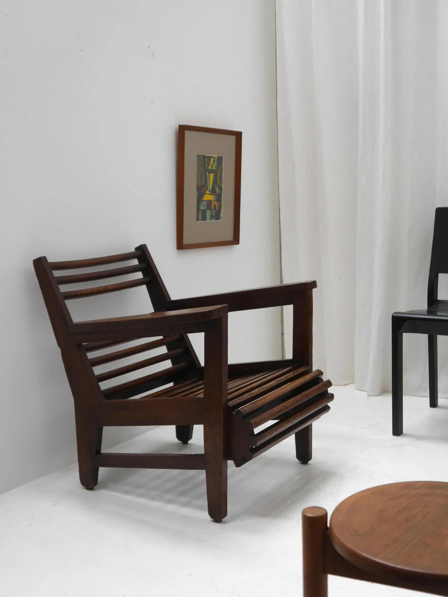 Modernist dark oak chair with angular frame and slatted rod seat and backrest,  circa 1930s/1940s. The family who previously owned this chair said their parents originally purchased it from Heal&rsquo;s. 

The curved front edge echoes an Adirondack c