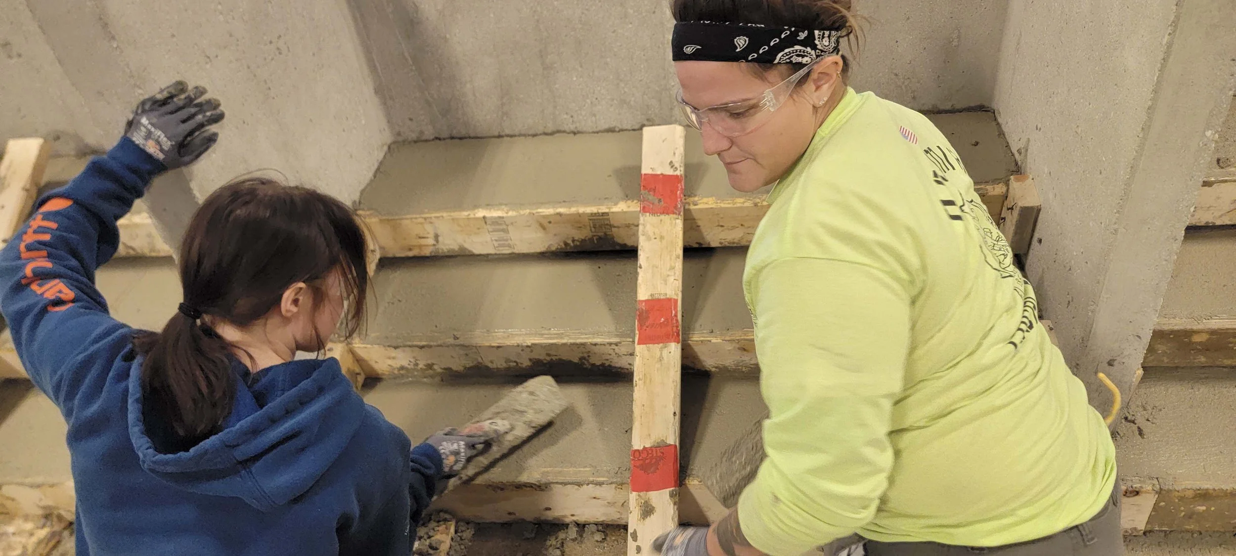 women-in-trades-building-trades-council-of-southern-wisconsin-ladies-leveling-concrete-stairs.jpg