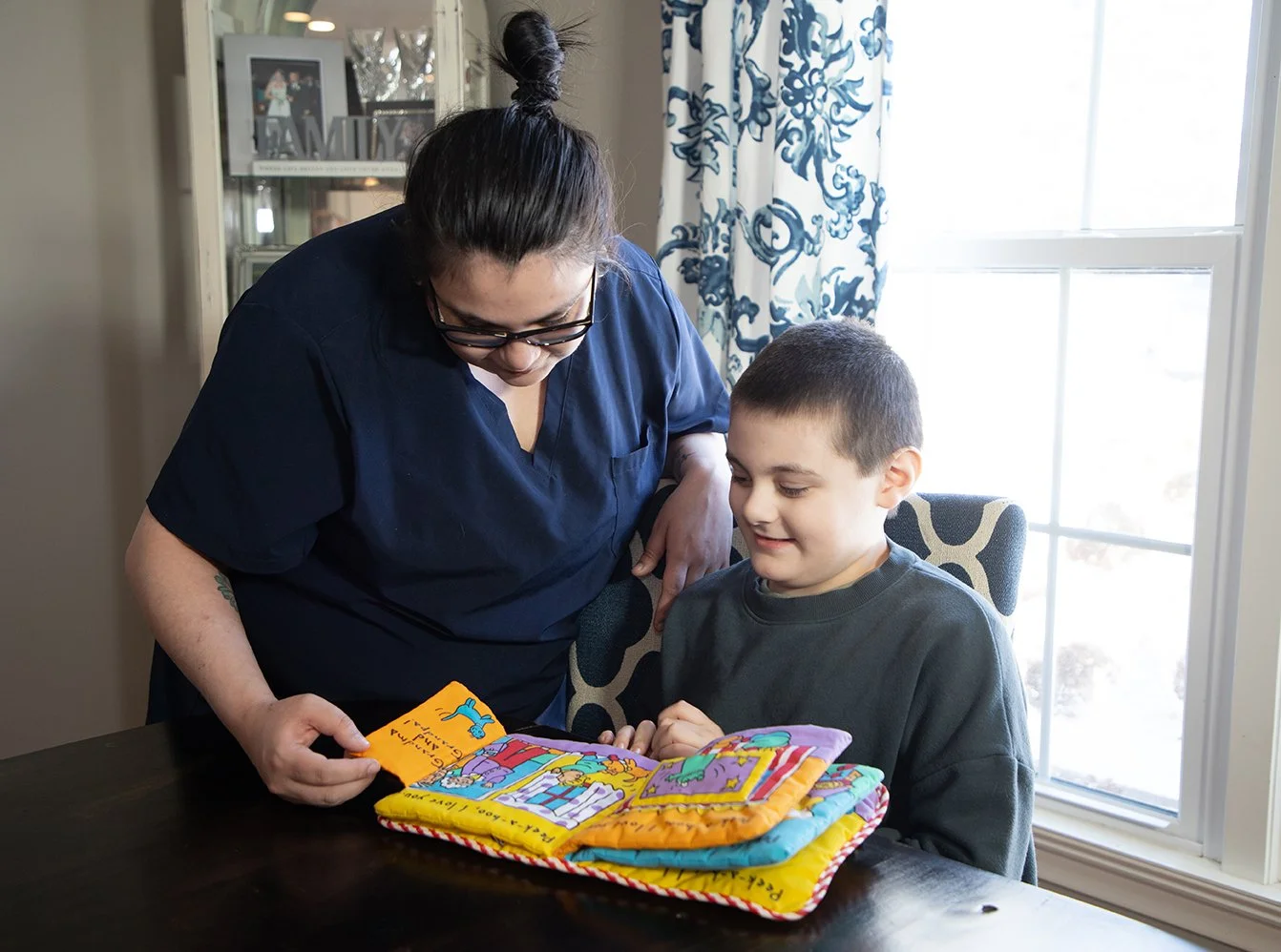 Autistic child enjoying learning time with a Caretech caregiver.