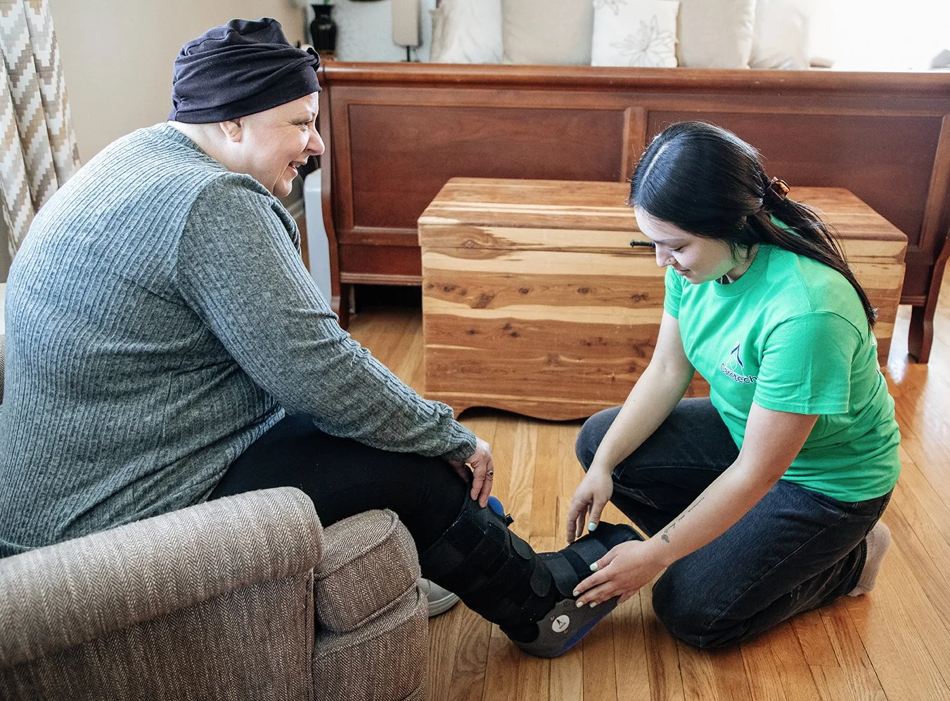 A Caretech caregiver assists an adult with physical disabilities.