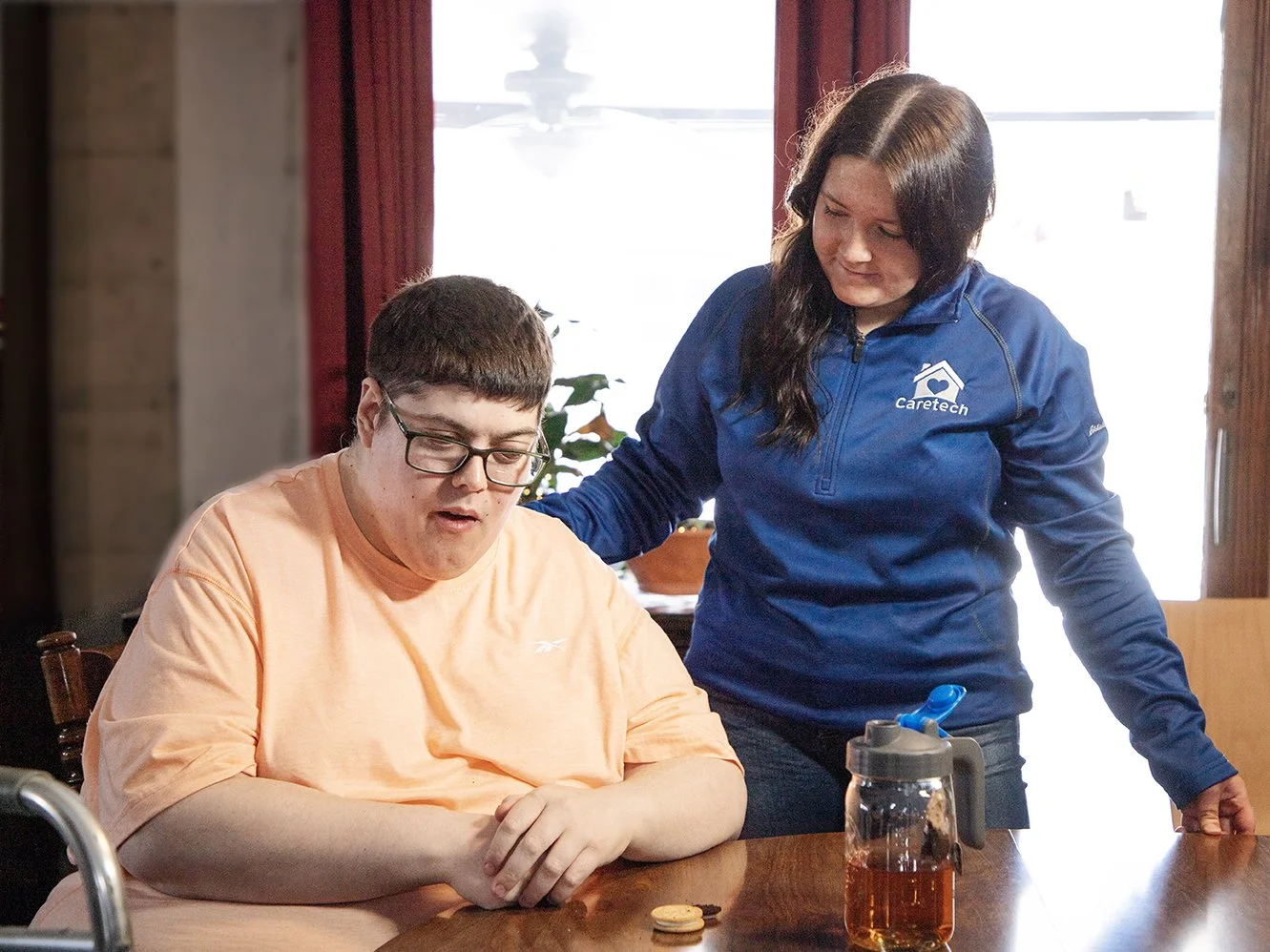 Caretech caregiver providing care for an individual living with an Intellectual Development Disability. 