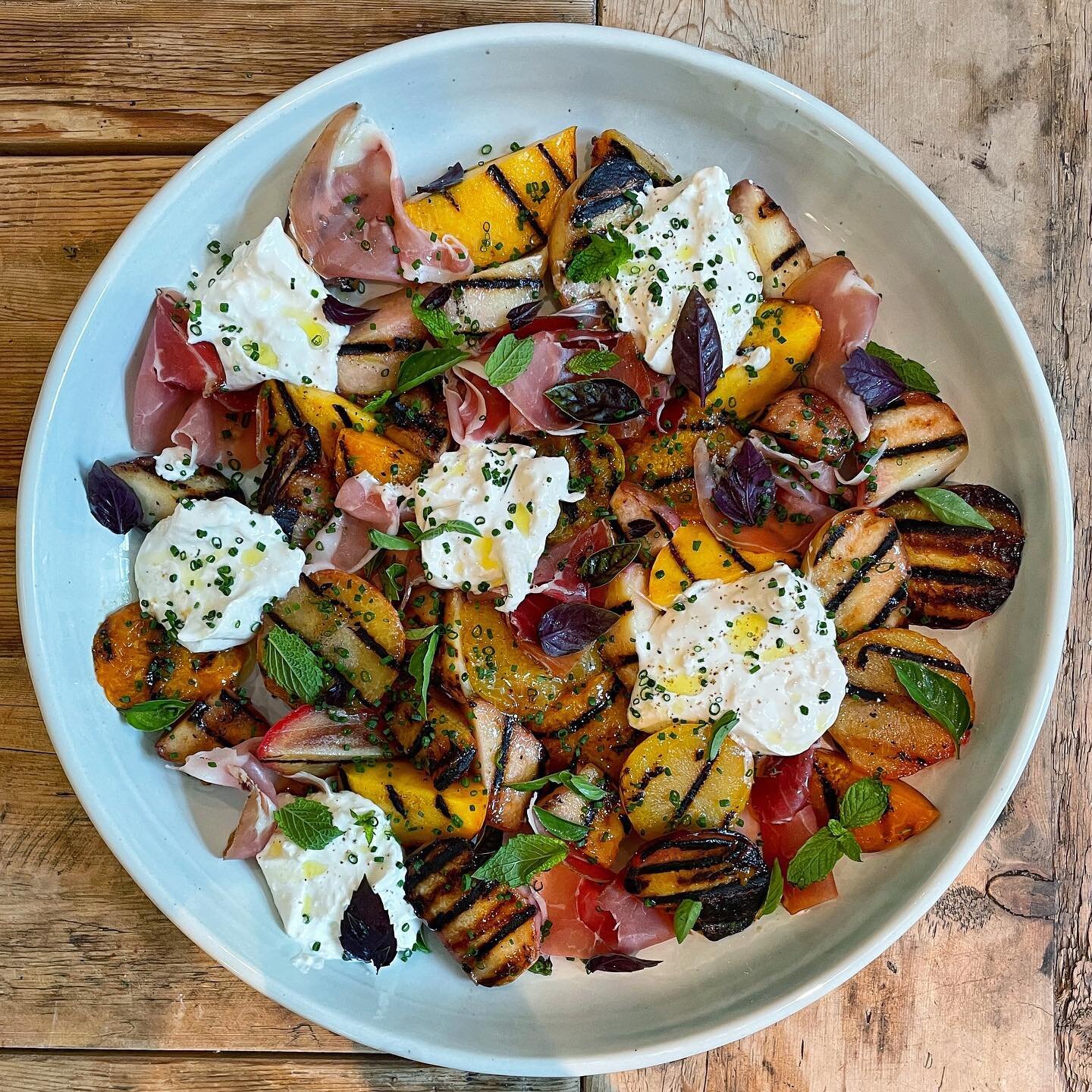 Grilled heirloom stone fruit and burrata salad with prosciutto and all the herbs from the garden