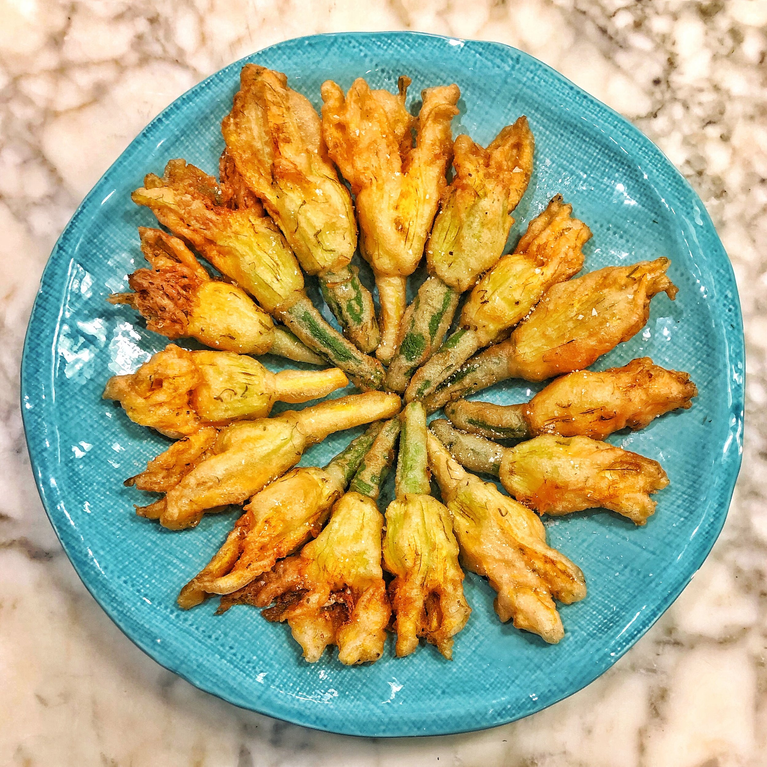 Crispy fried squash blossoms stuffed with fresh ricotta, goat cheese and lots of fresh herbs