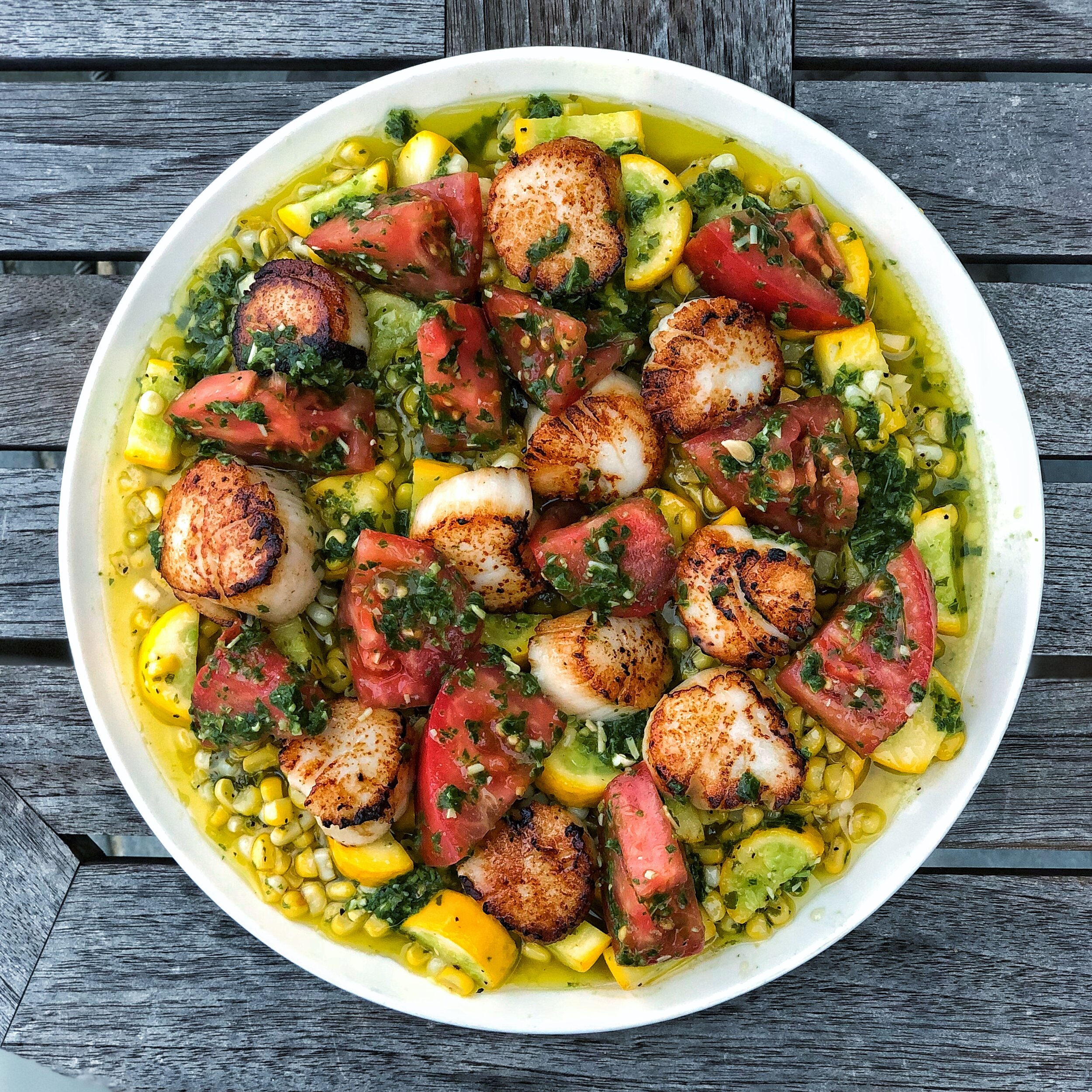 Seared Diver Scallops over a summer corn saute with heirloom tomatoes and lemon basil pesto