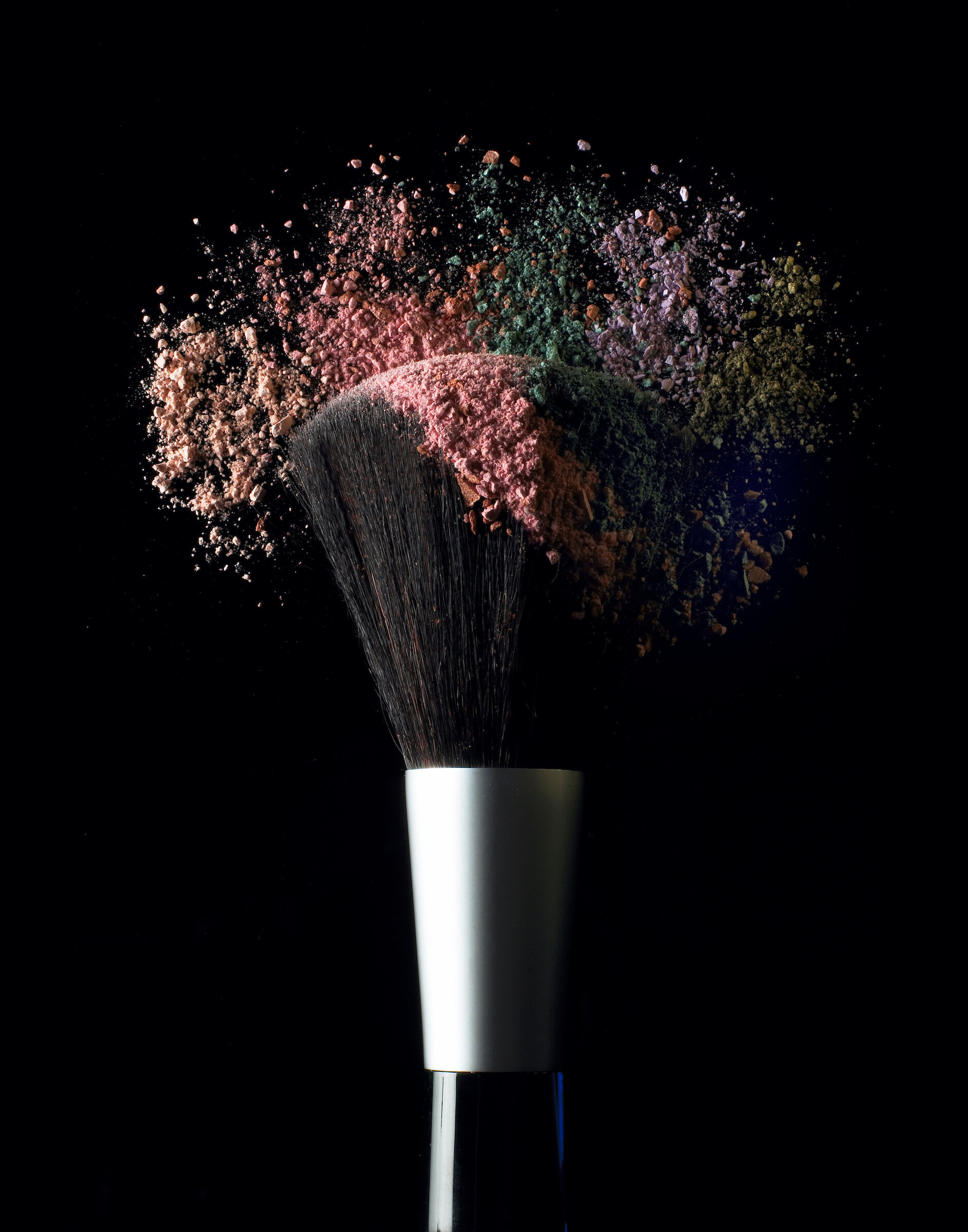 Make up brush and colored powder on black.jpg
