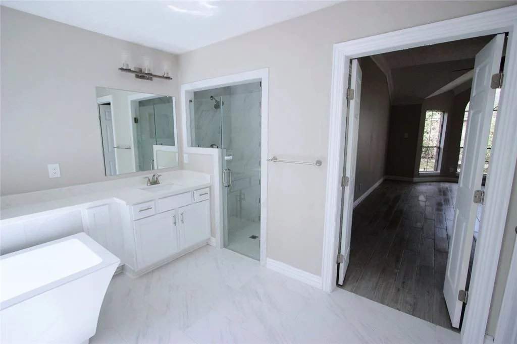 En suite primary bathroom with a walk-in-shower.