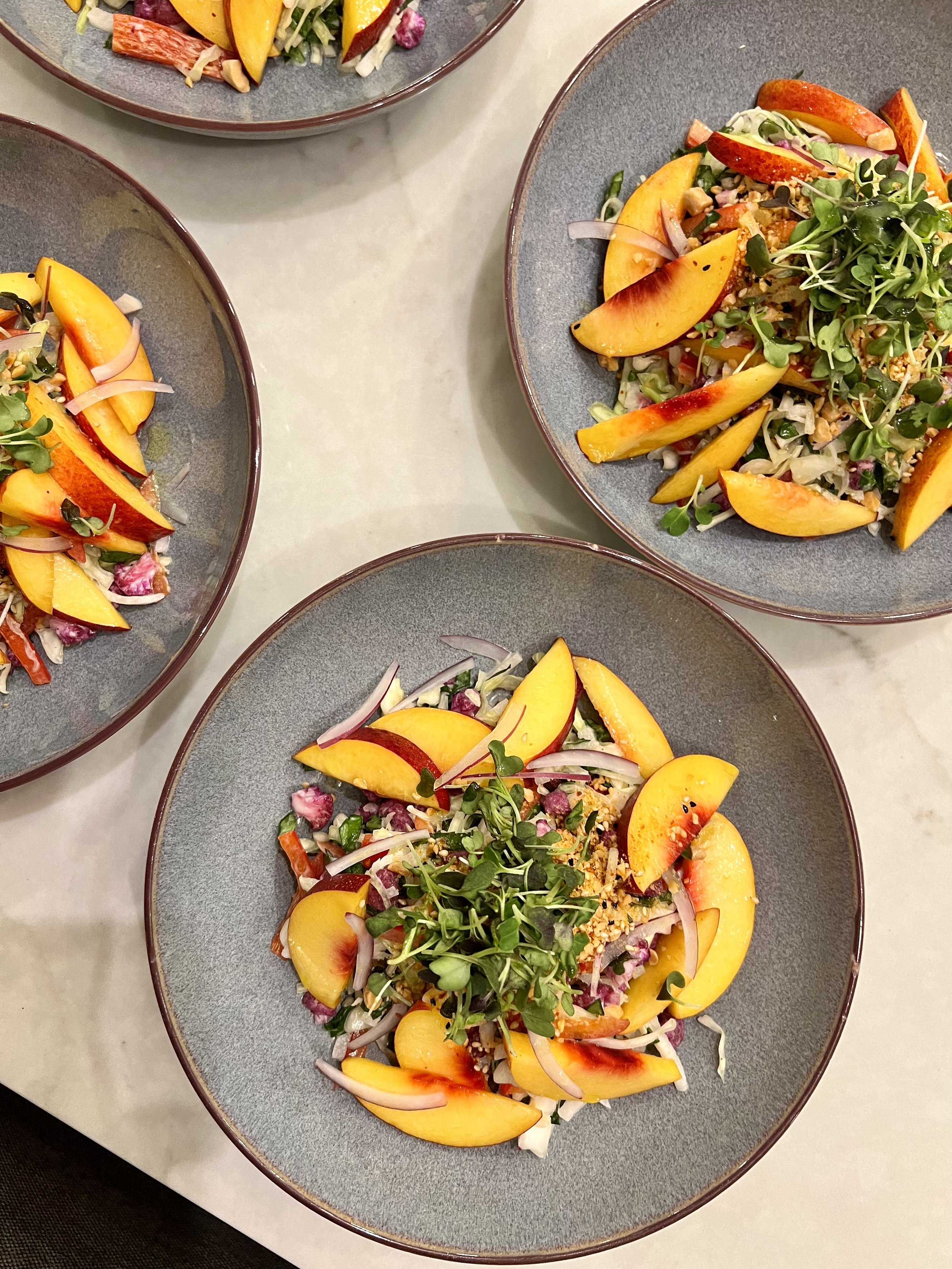 Ferncook supperclub vibrant peach salad with summer vegetables and microgreens