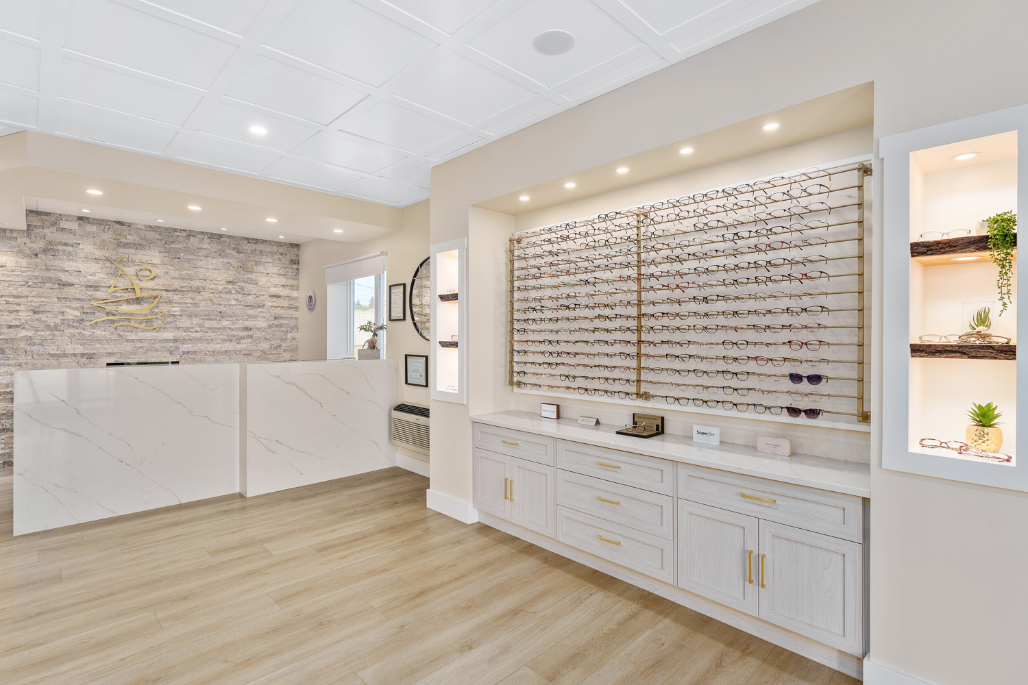 A very clean and bright front reception area complete with quartz countertops, custom-made eyeglass racks, and inviting color tones
