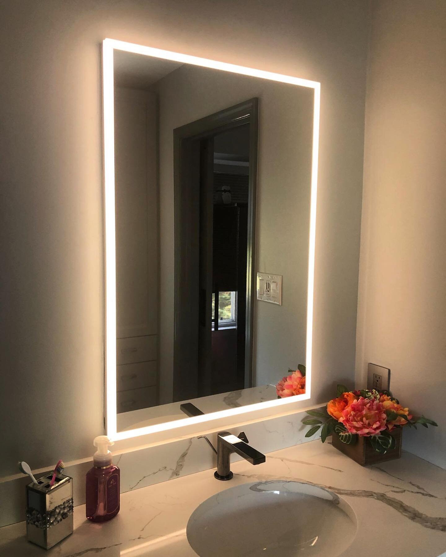A moody little bathroom for this gloomy Monday.  The LED Halo mirror is by @fleurco.inc, available through Beebe&rsquo;s in Hamilton, who also supplied the faucet.  Gorgeous countertop by @cosmosmarblegranite.  Simple, classic design by @cabsbyamyand