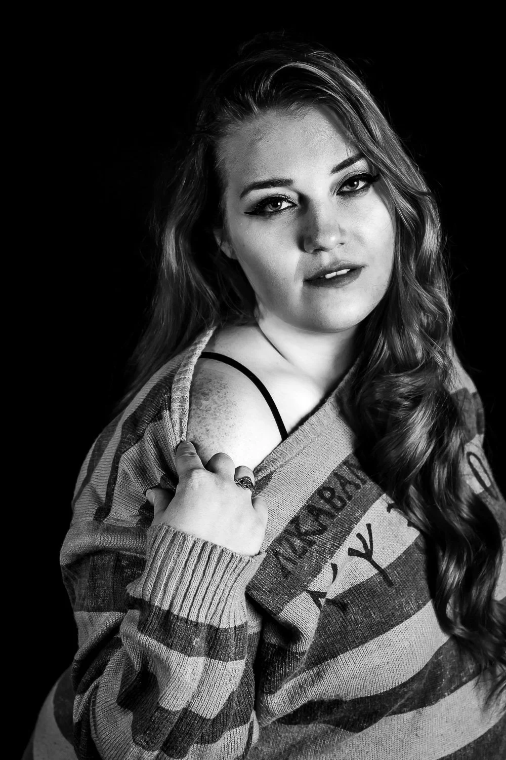 Woman in a striped sweater, black and white boudoir portrait in Maine