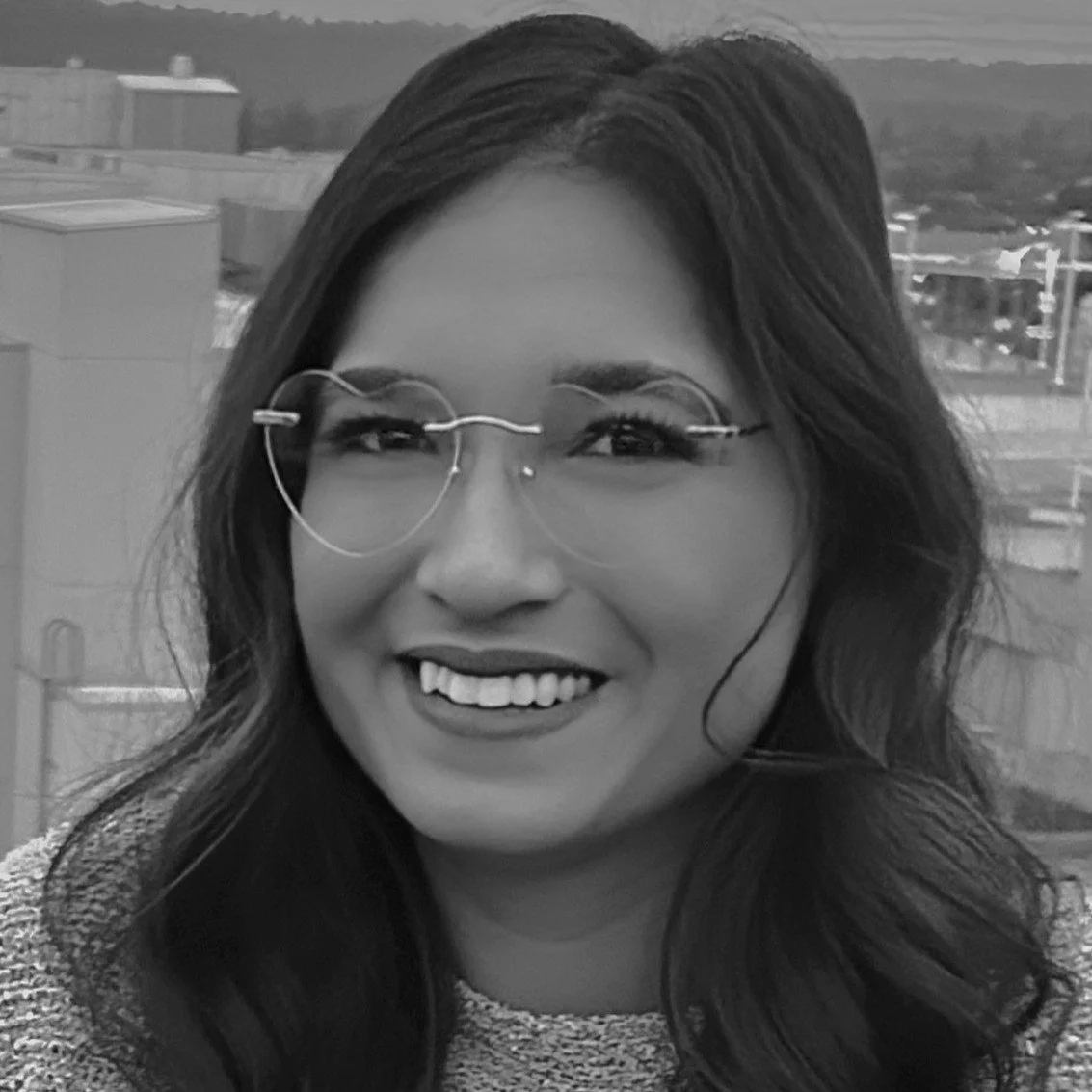 Black and white portrait of Eva Zapata, Community Engagement & Program Coordinator.
