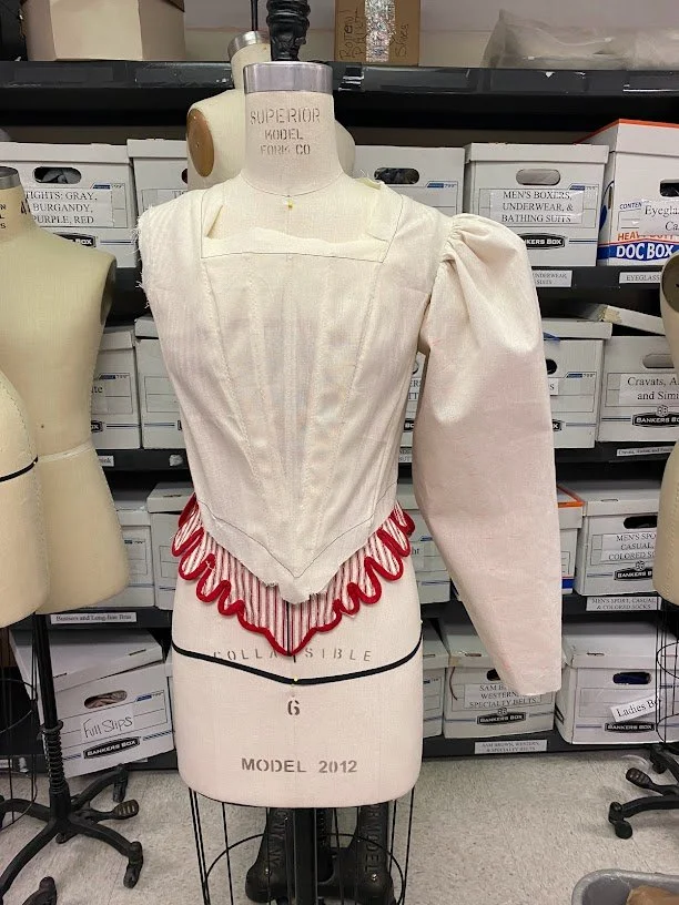 A muslin mockup of the bodice with only one sleeve