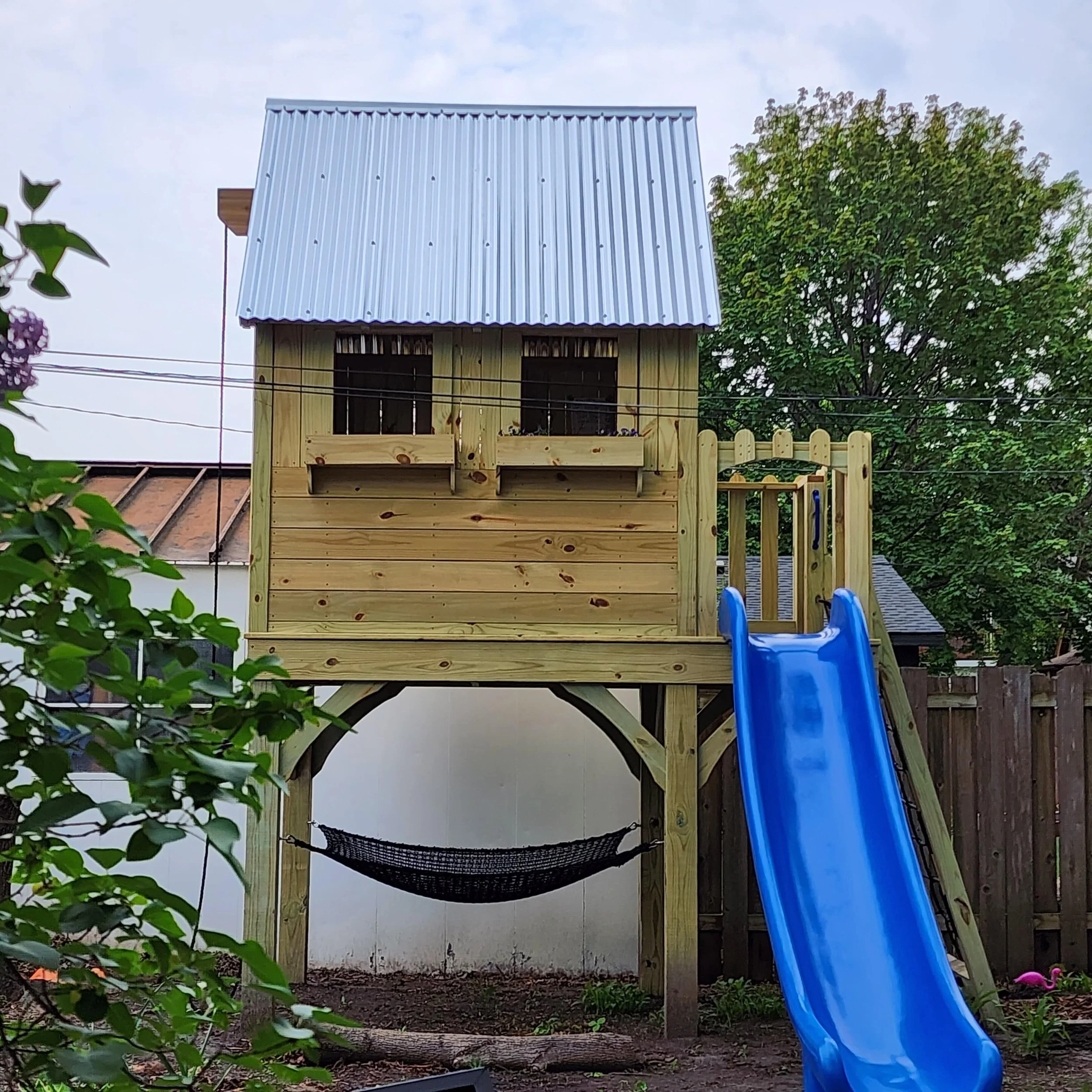 custom play structure with blue slide