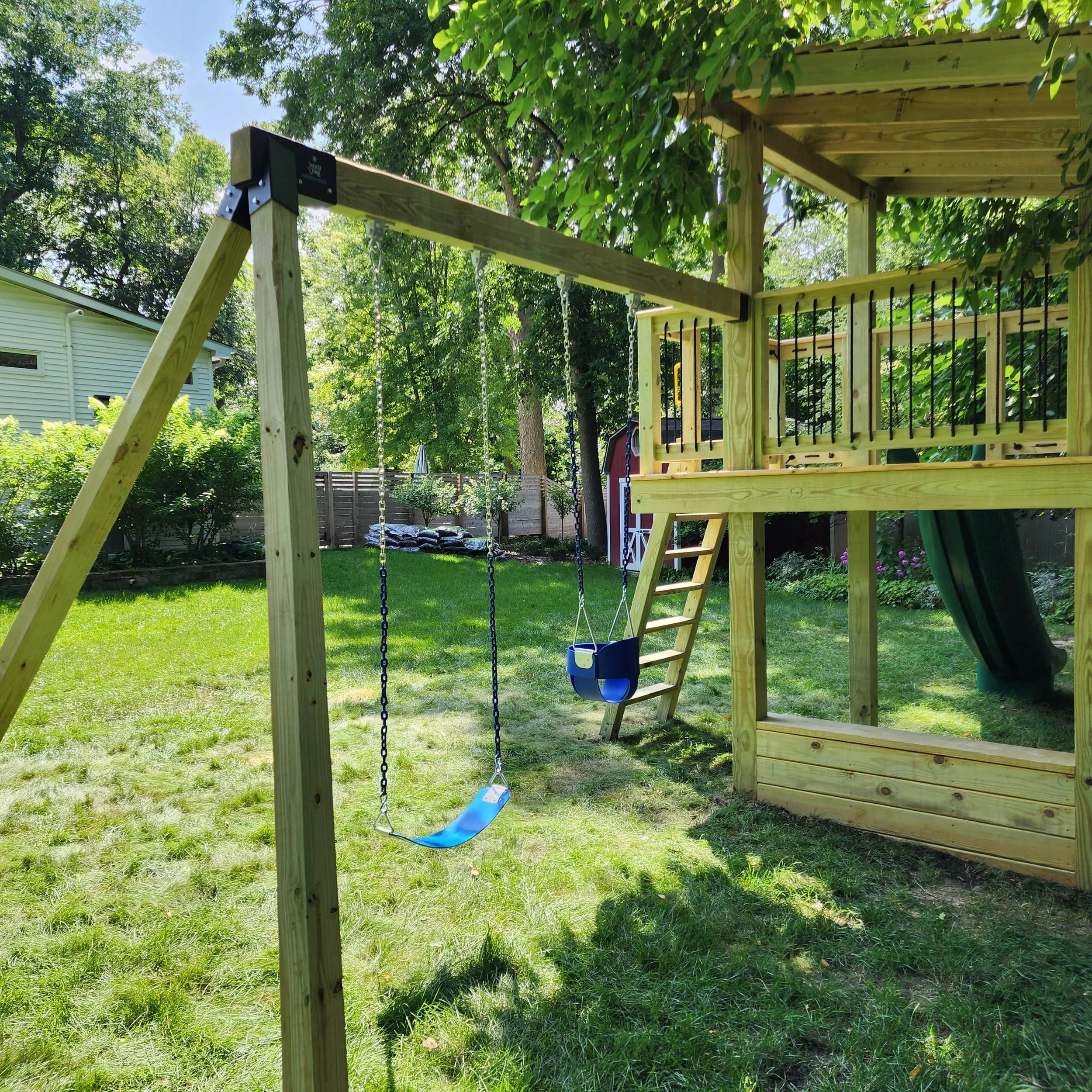 custom backyard swing set with blue swings and infant swing