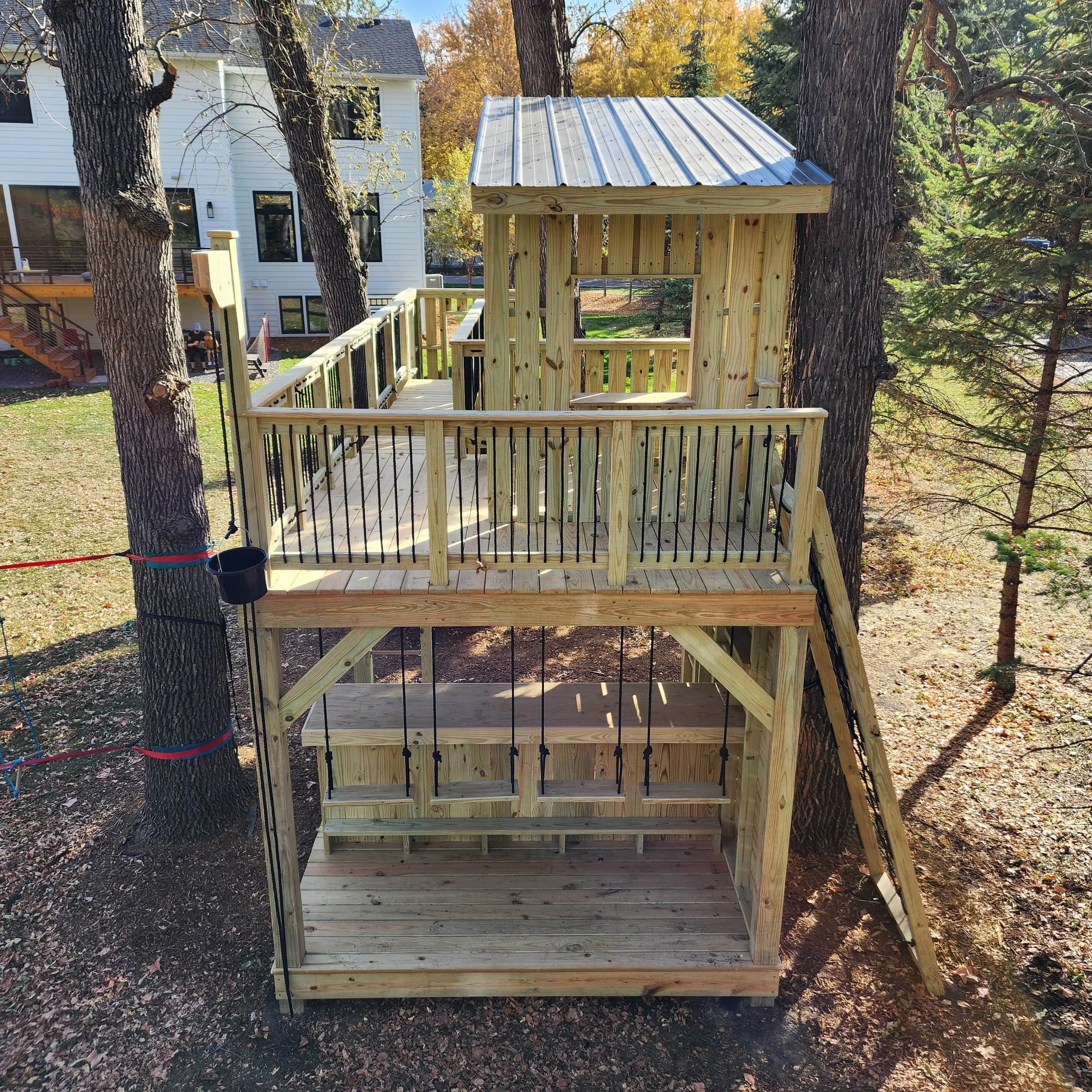 custom tree fort with outdoor bar