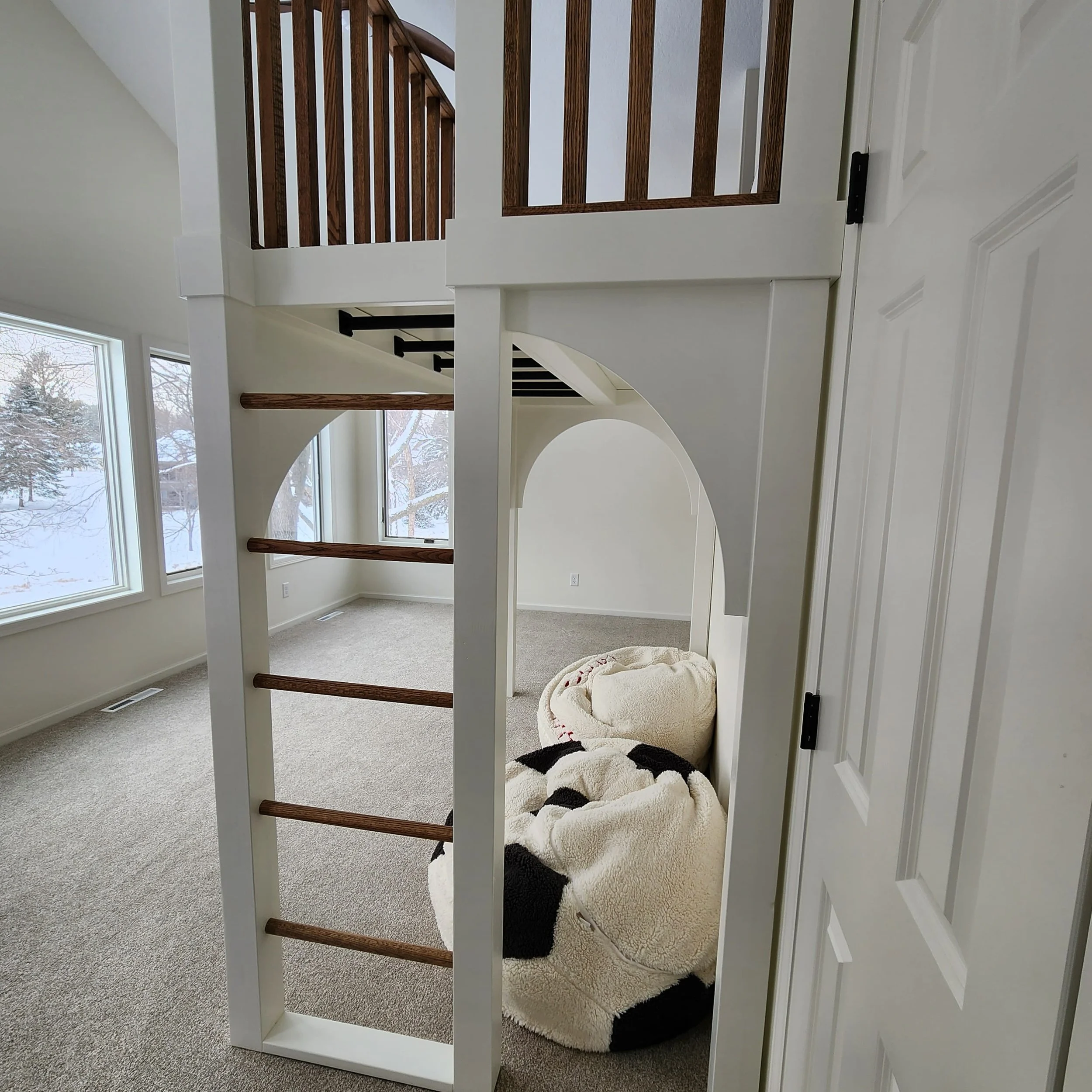 ladder-to-loft-and-monkey-bars-white-play-structure-wood-railing-modern-playroom.jpg