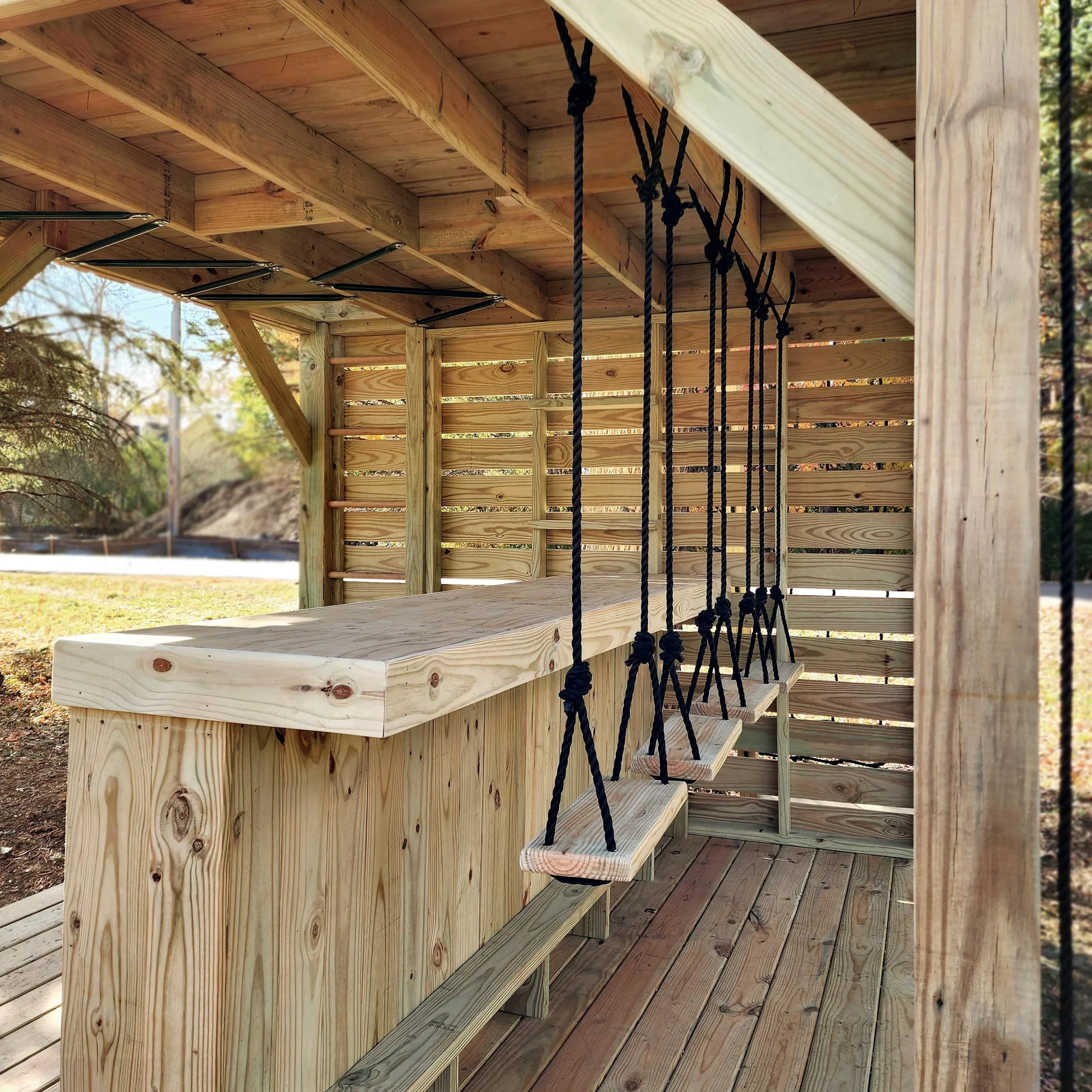 custom tree fort bar with swing seats