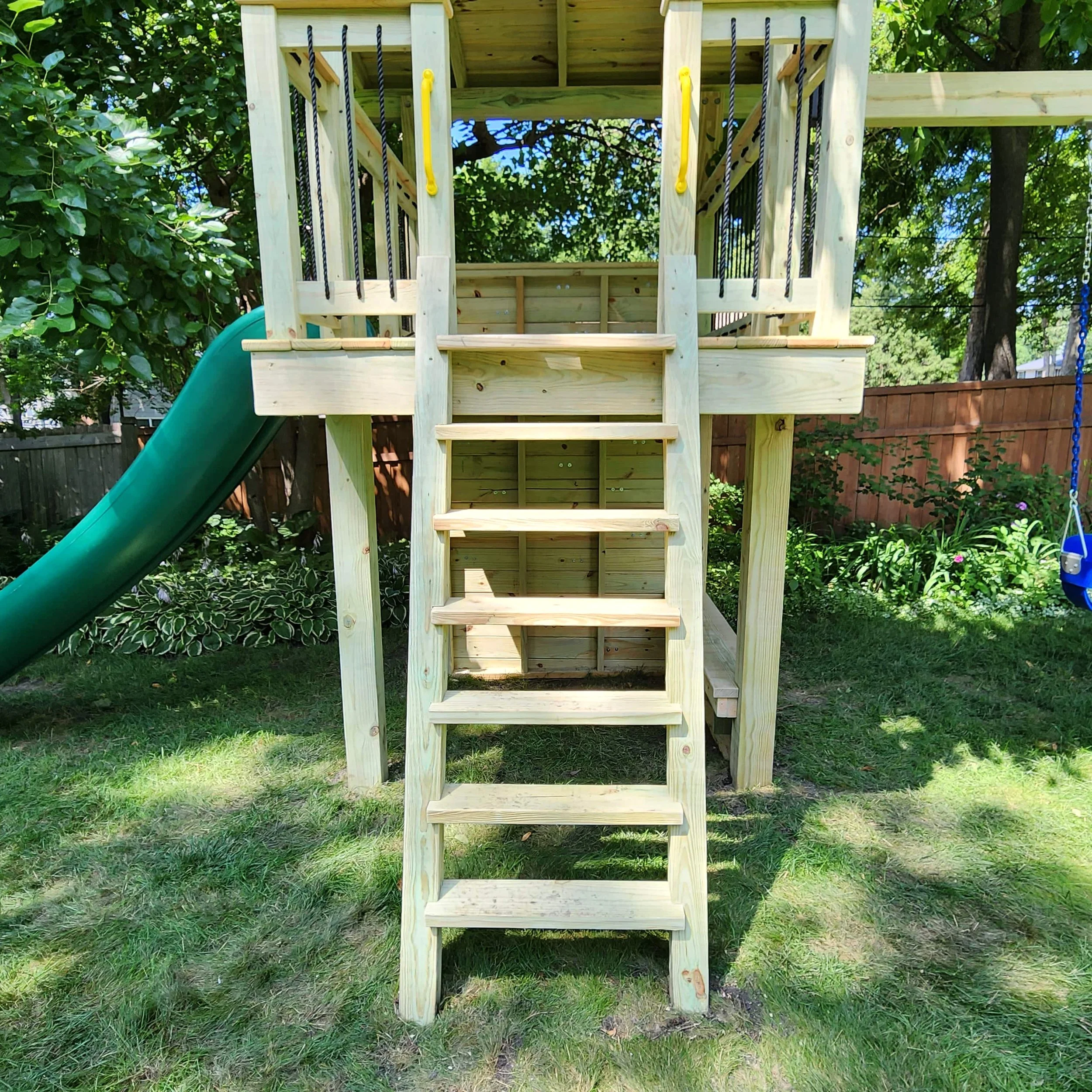custom backyard swing set ships ladder leading up to open clubhouse